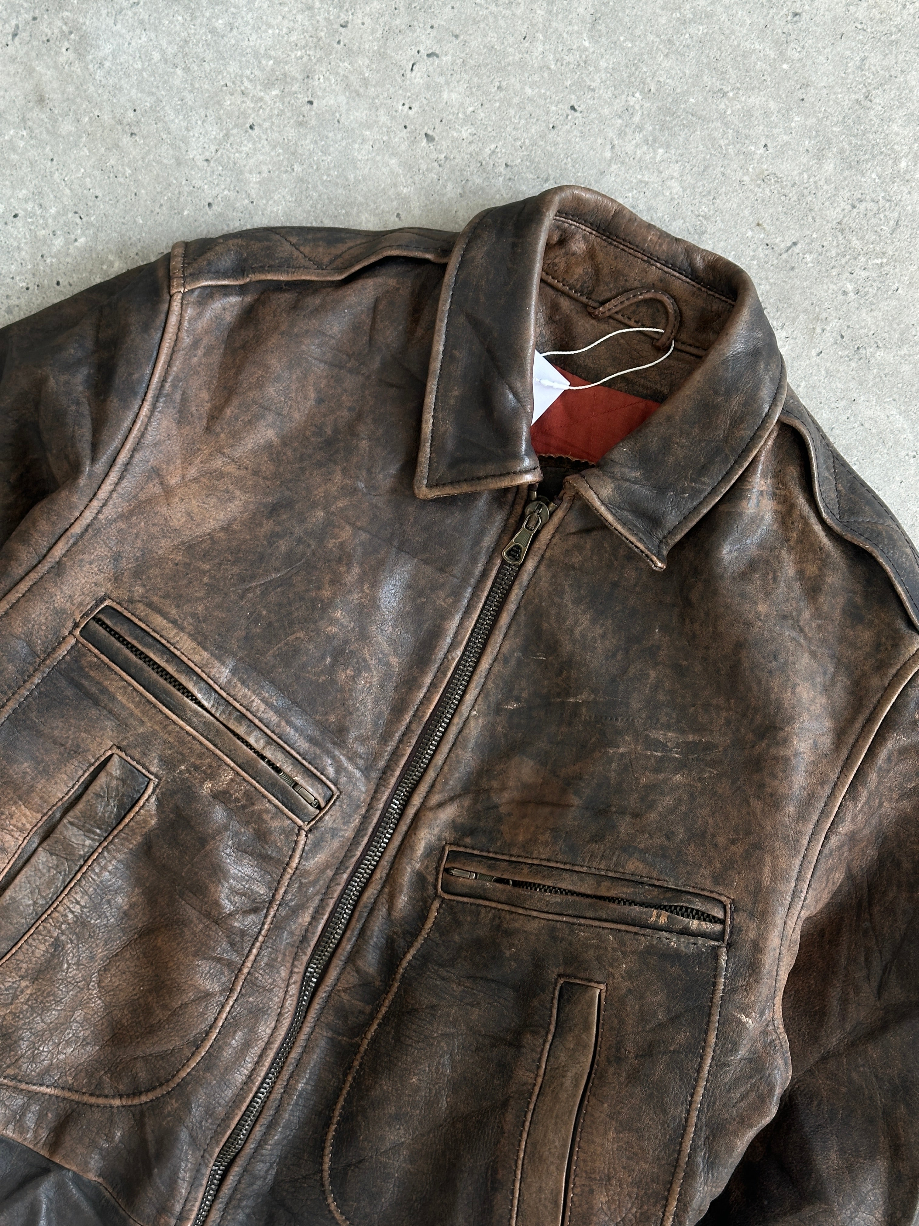 Vintage distressed leather bomber jacket in size M/L, featuring a rugged design and classic style.