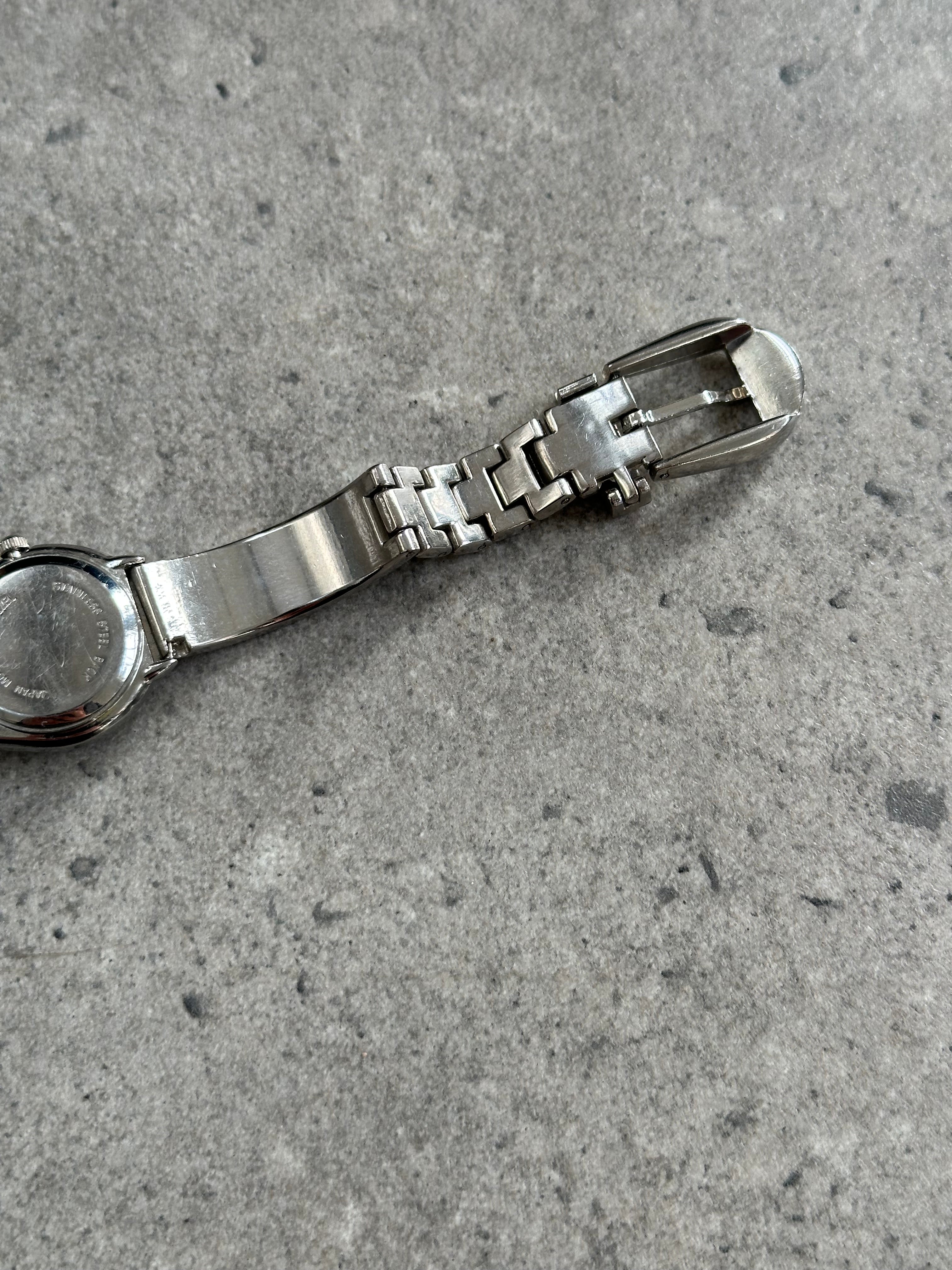 Gucci 1990s stainless steel quartz watch with round dial and sleek design, featuring the iconic Gucci branding.