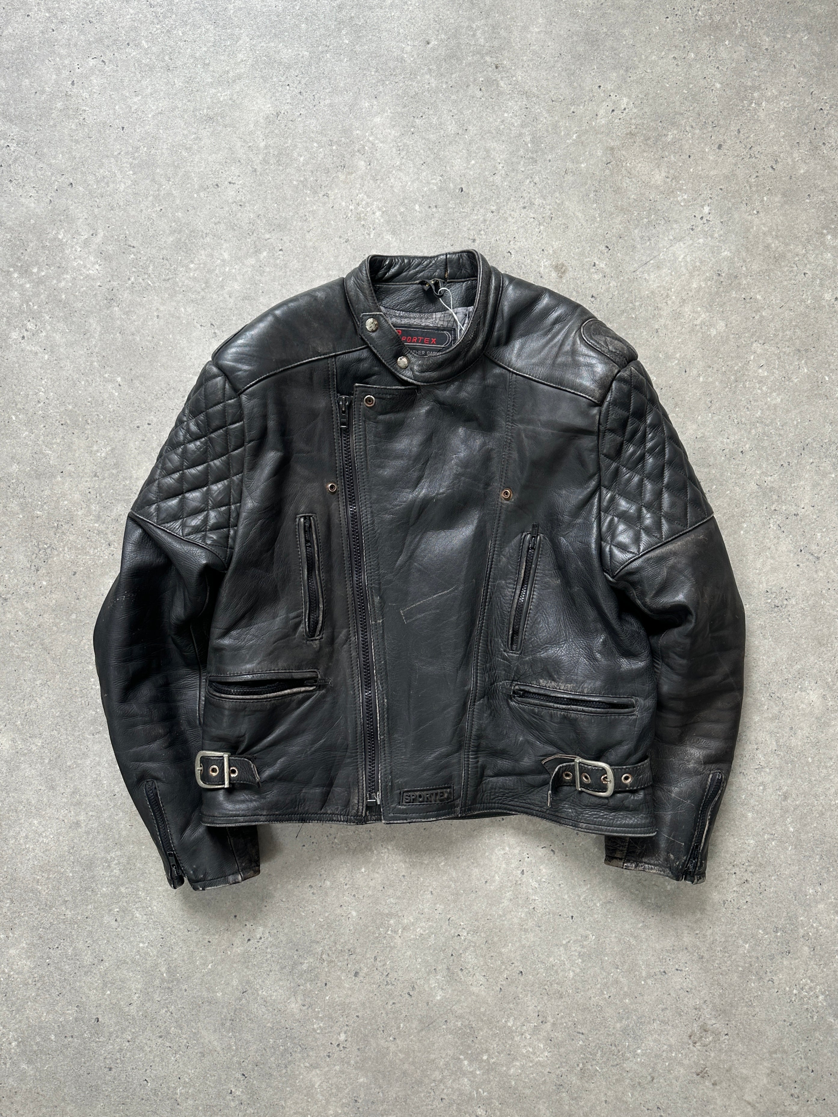 Vintage distressed motorcycle leather jacket in size L/XL, featuring rugged design and classic biker style.