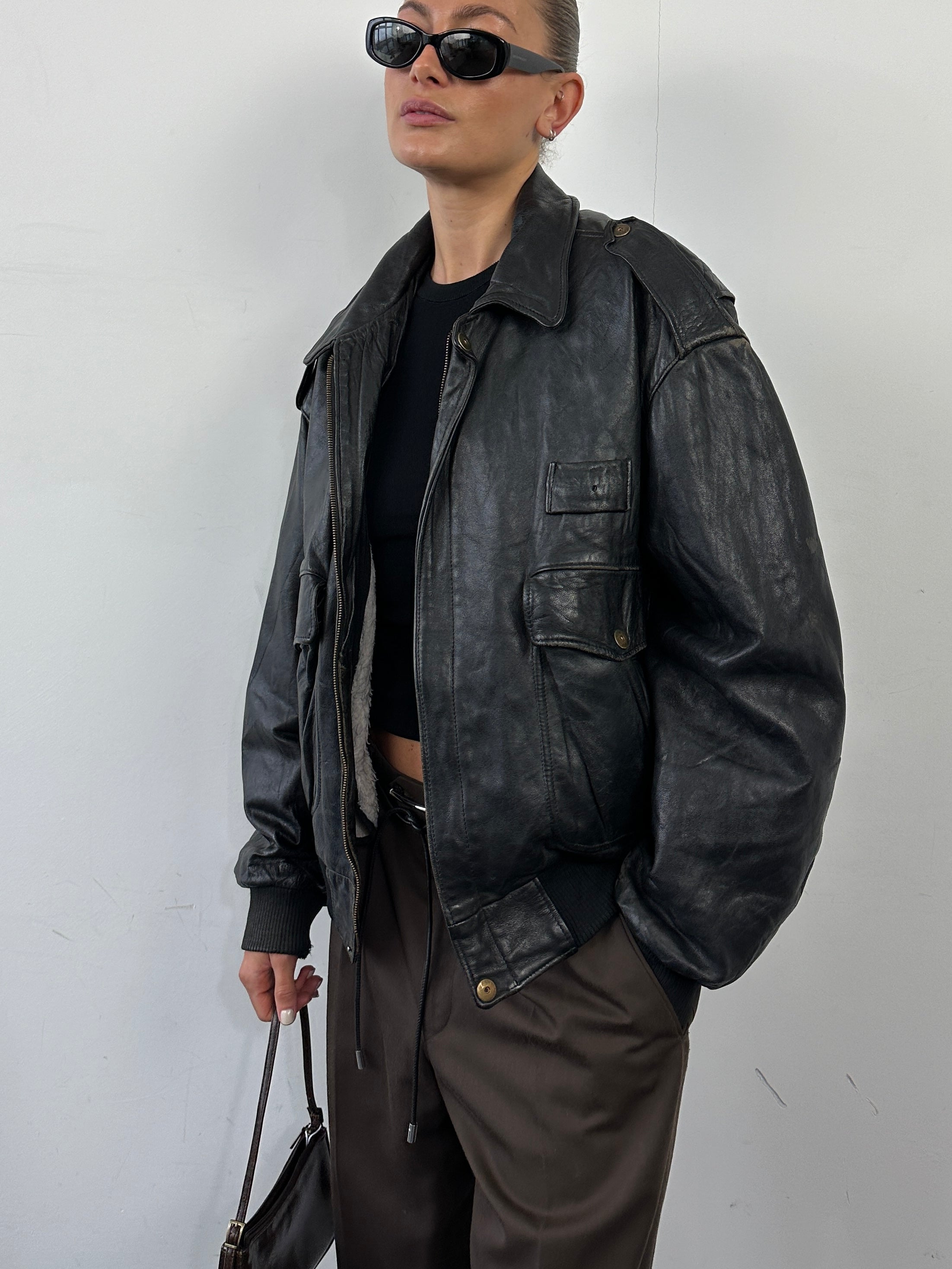 Vintage Italian leather bomber jacket with removable fleece lining, size large, featuring classic design and rugged style.