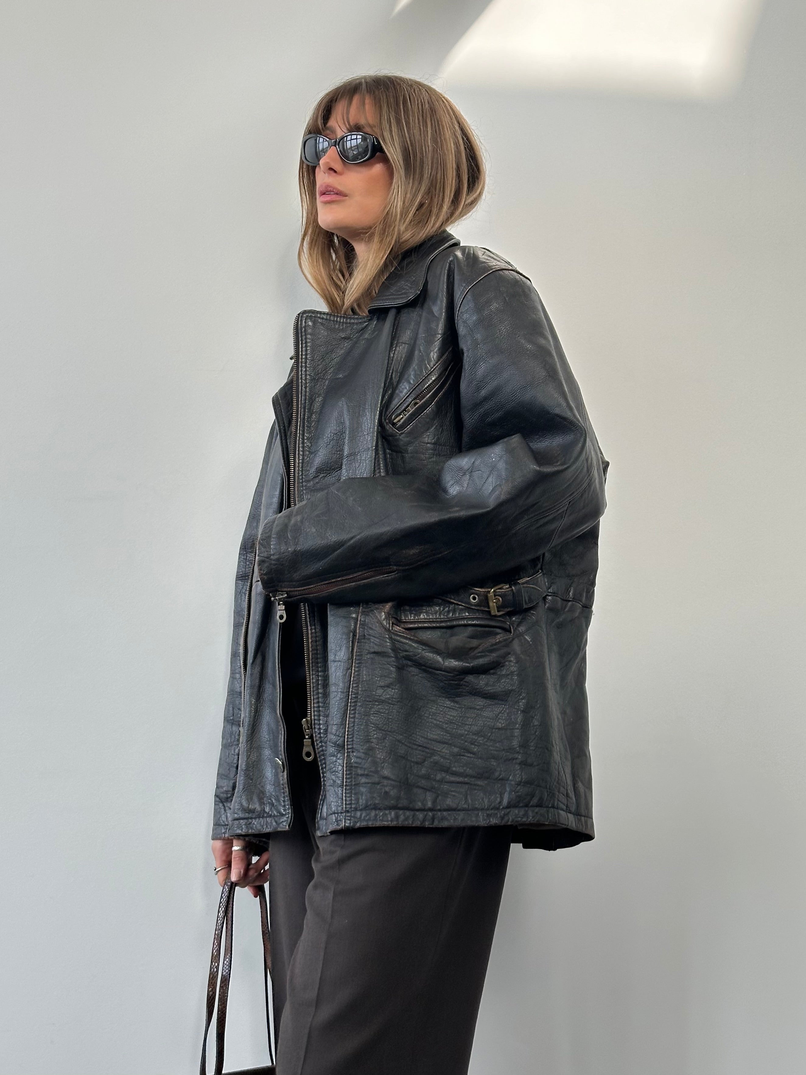 Vintage distressed leather jacket in XL, featuring a rugged look with worn leather and classic design details.