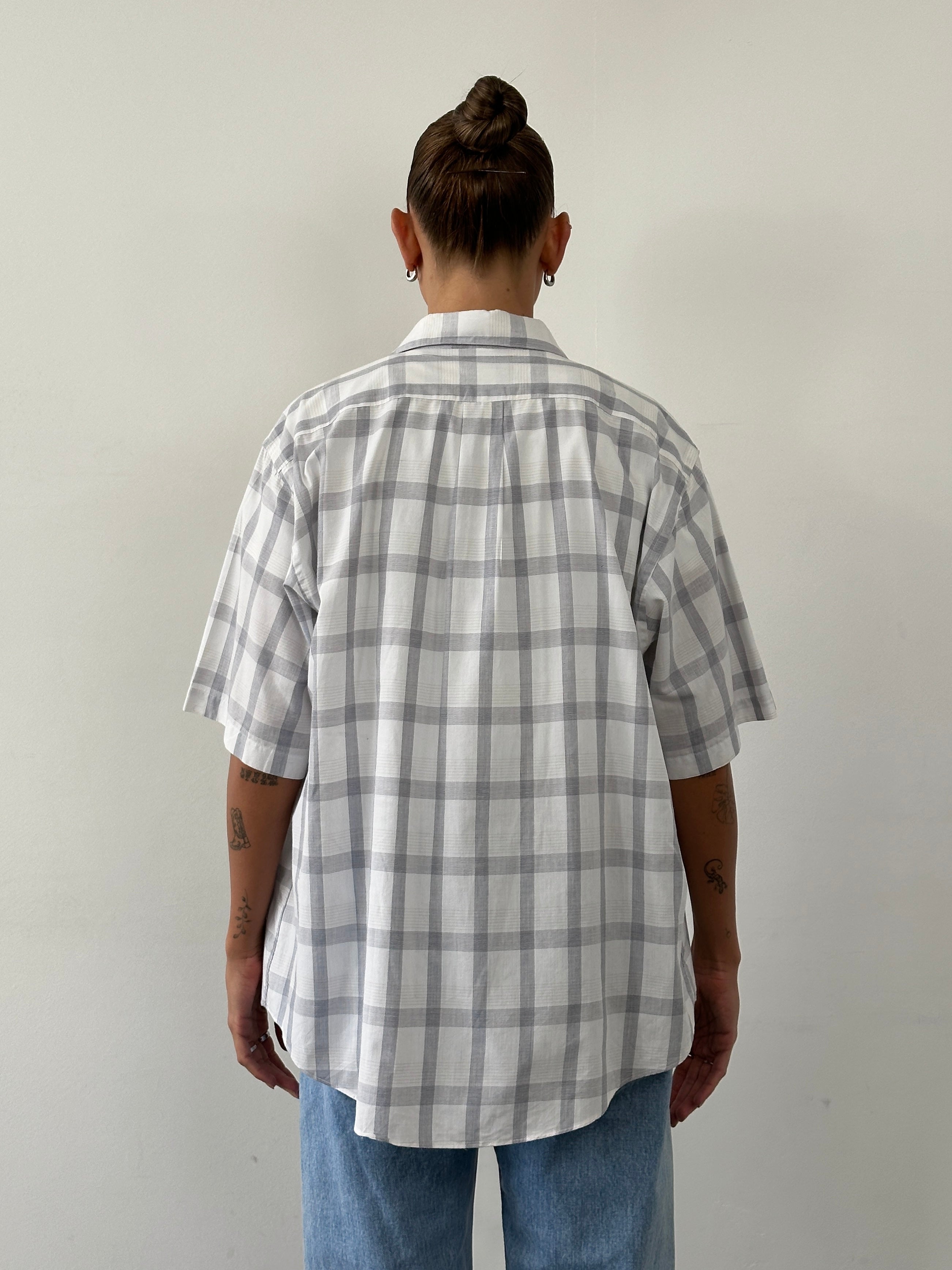 Christian Dior 1990s check cotton shirt in XL, featuring classic pattern and button-front design, displayed on a hanger.