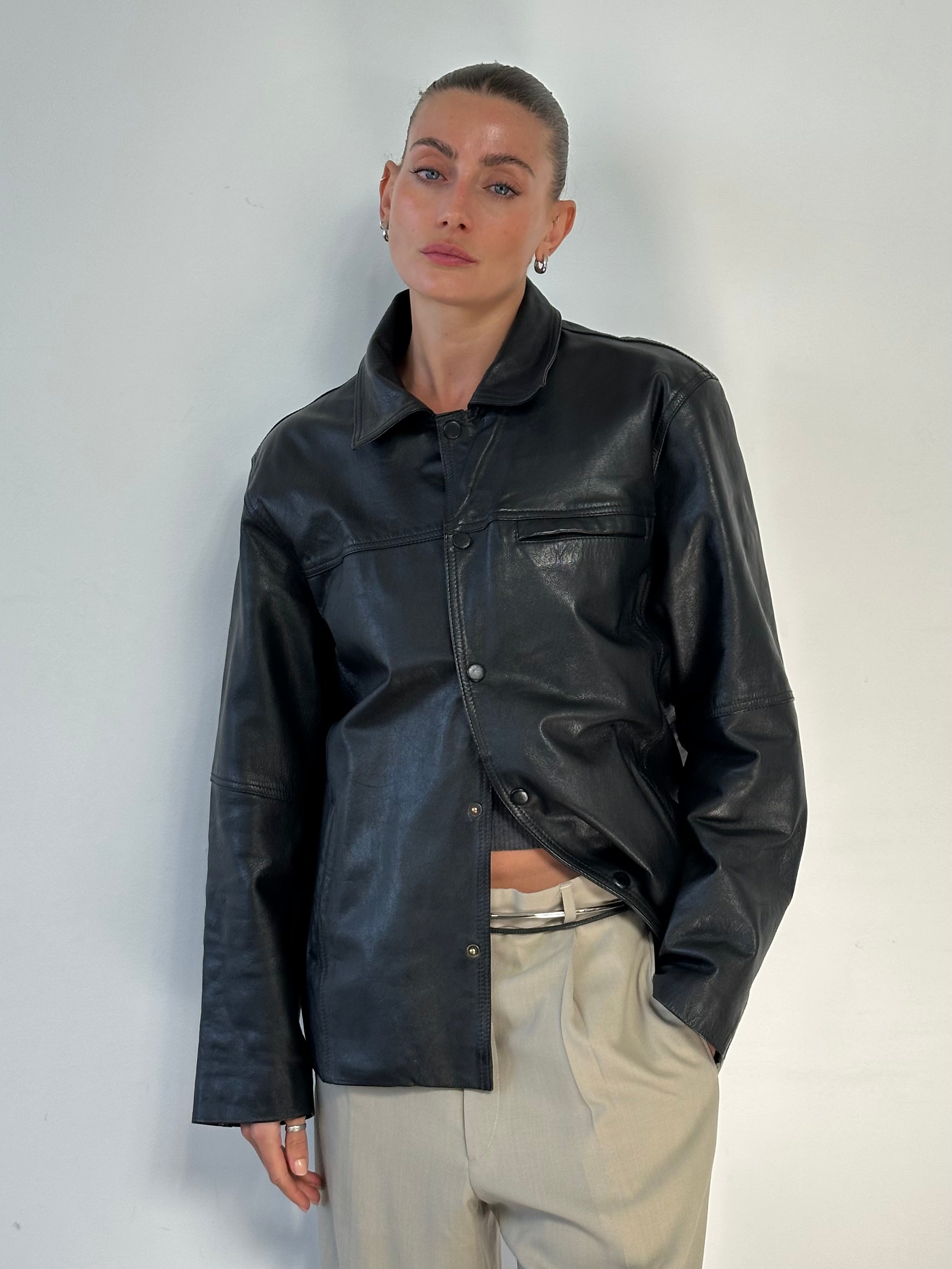 Vintage minimal leather jacket in size M/L, featuring a classic design with clean lines and smooth leather finish.