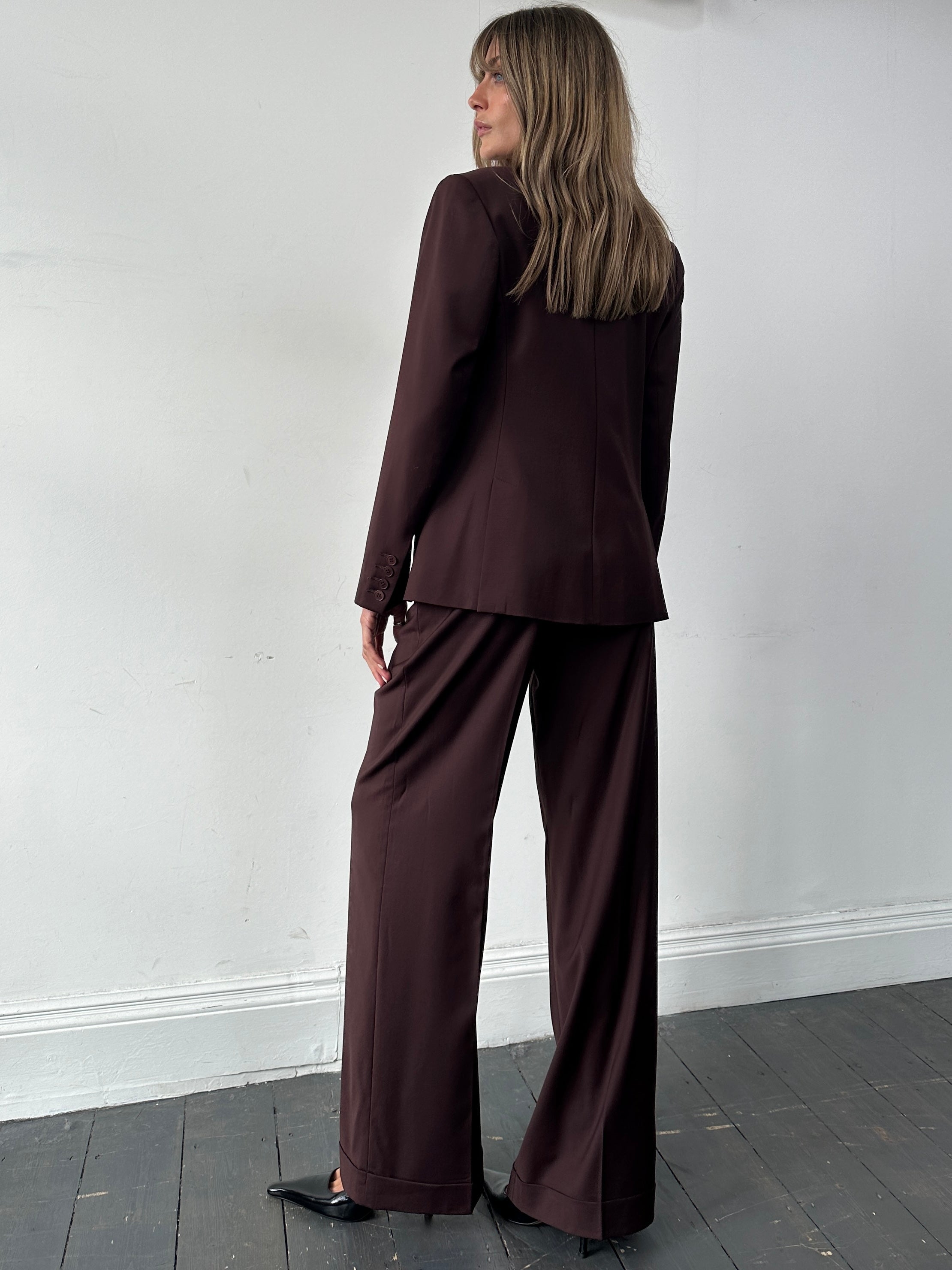 Max Studio wool jumpsuit with wide-leg design, single-breasted style, in size M, shown hanging on a mannequin.