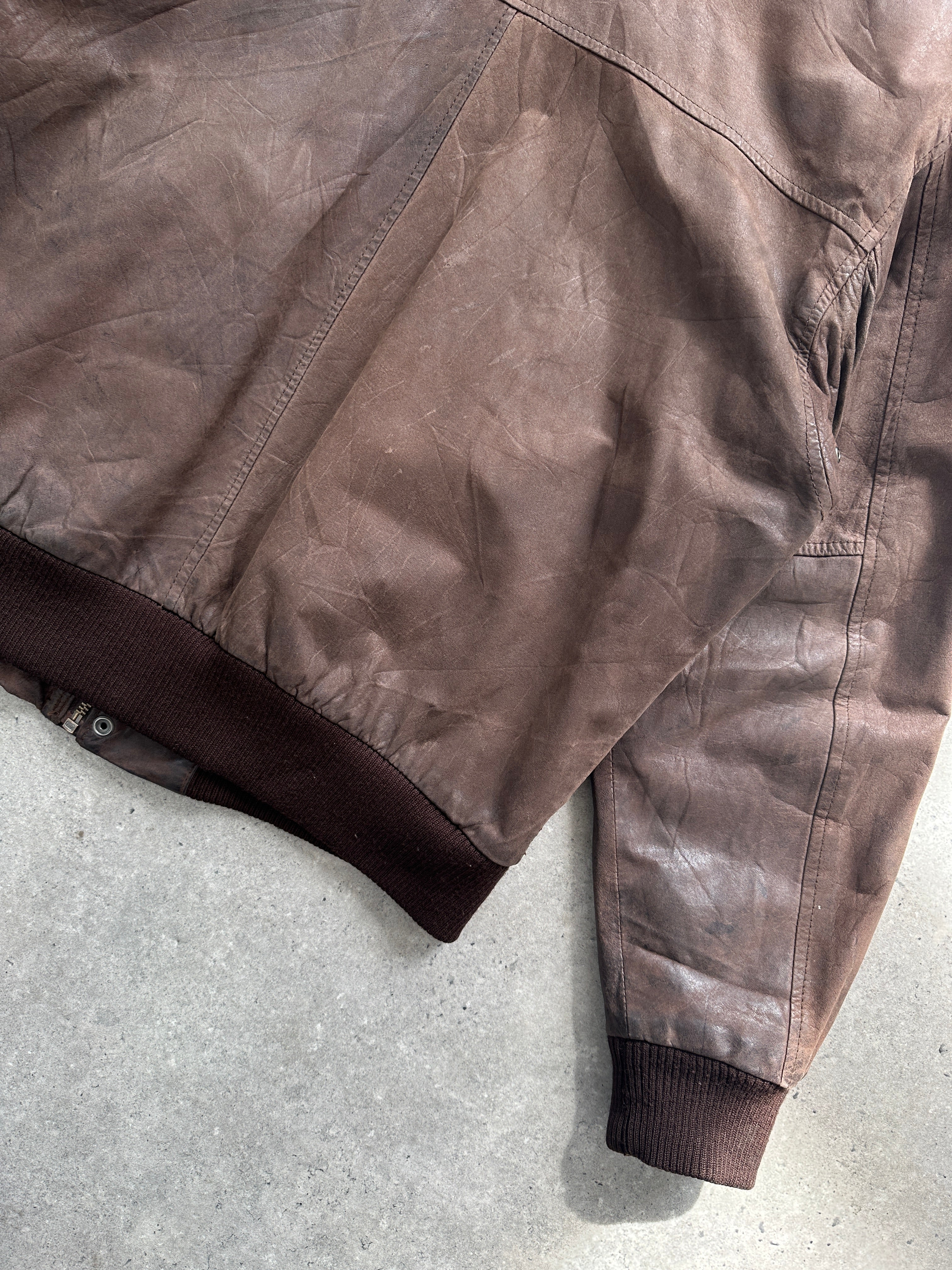 Vintage distressed leather bomber jacket in size L, featuring a classic style and rugged textured finish.