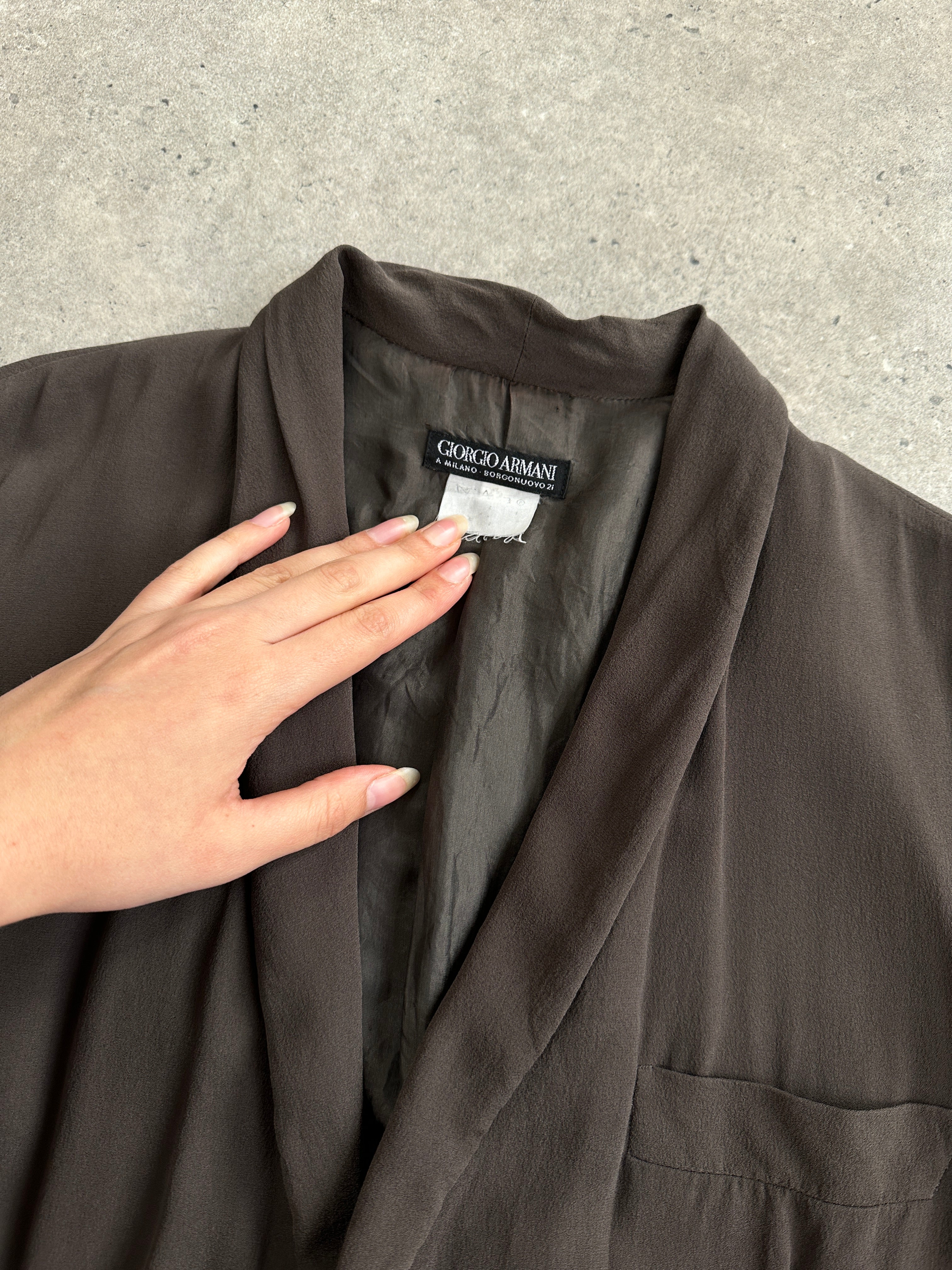 Giorgio Armani Black Label silk blazer in black, tailored fit with sleek lapels, shown on a mannequin.