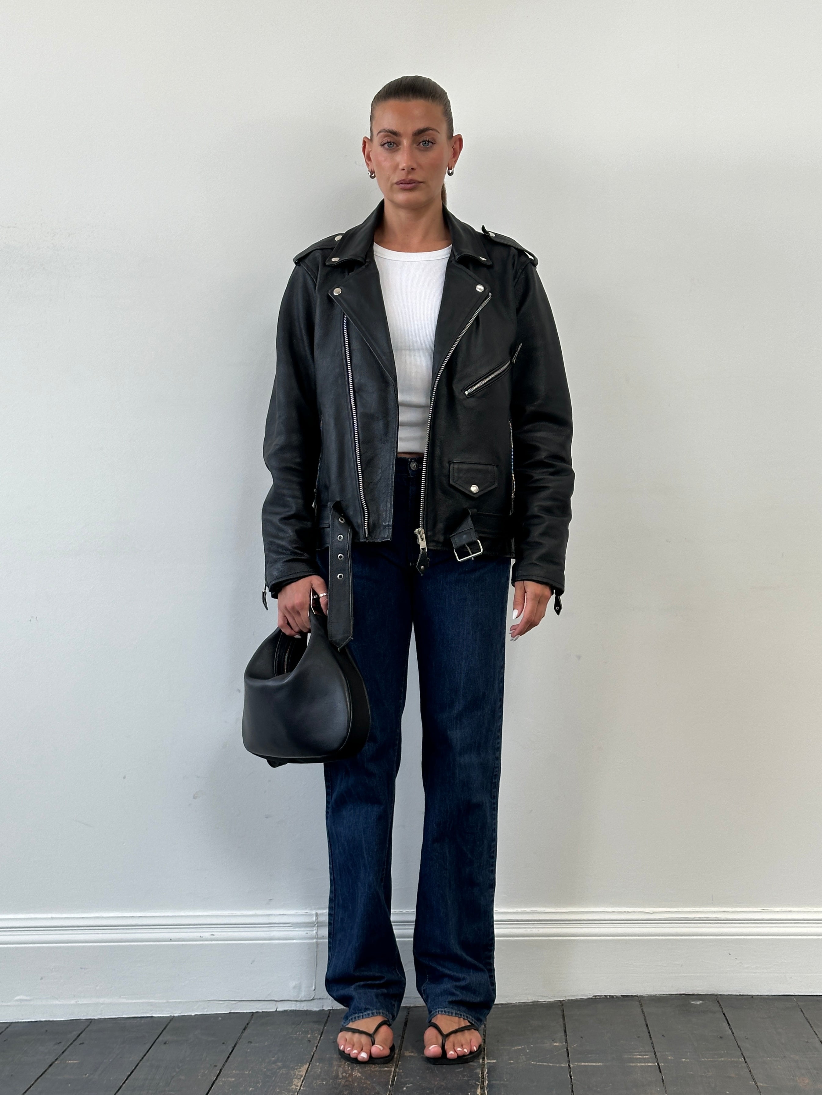 Vintage leather biker jacket in size M/L, featuring classic design with rugged details and a timeless style.