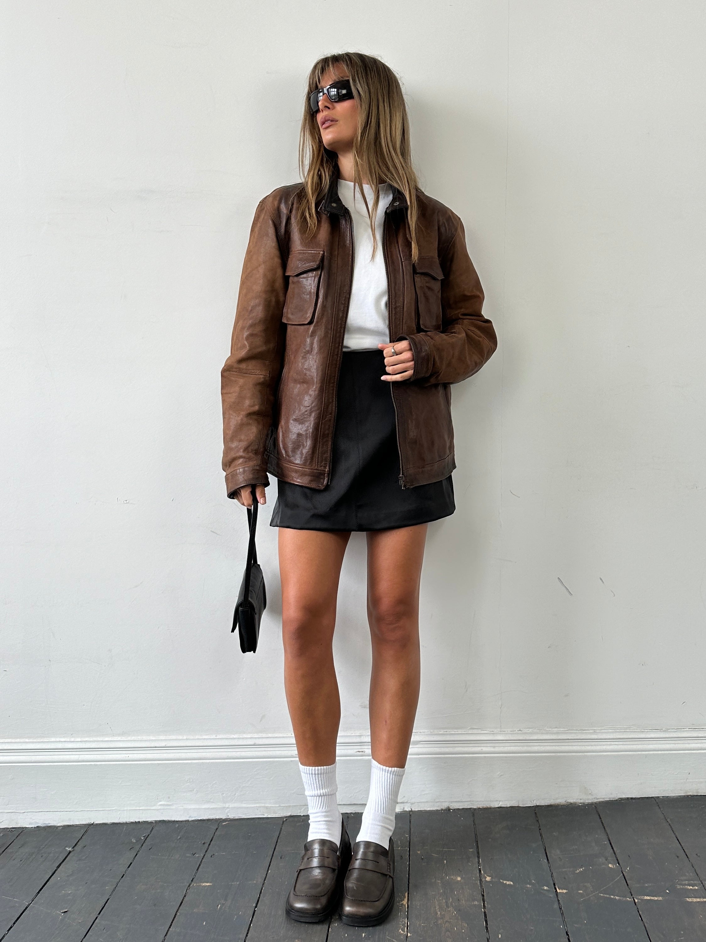 Vintage Italian vintage aged leather jacket, size large, featuring classic design and rich patina, displayed on a hanger.