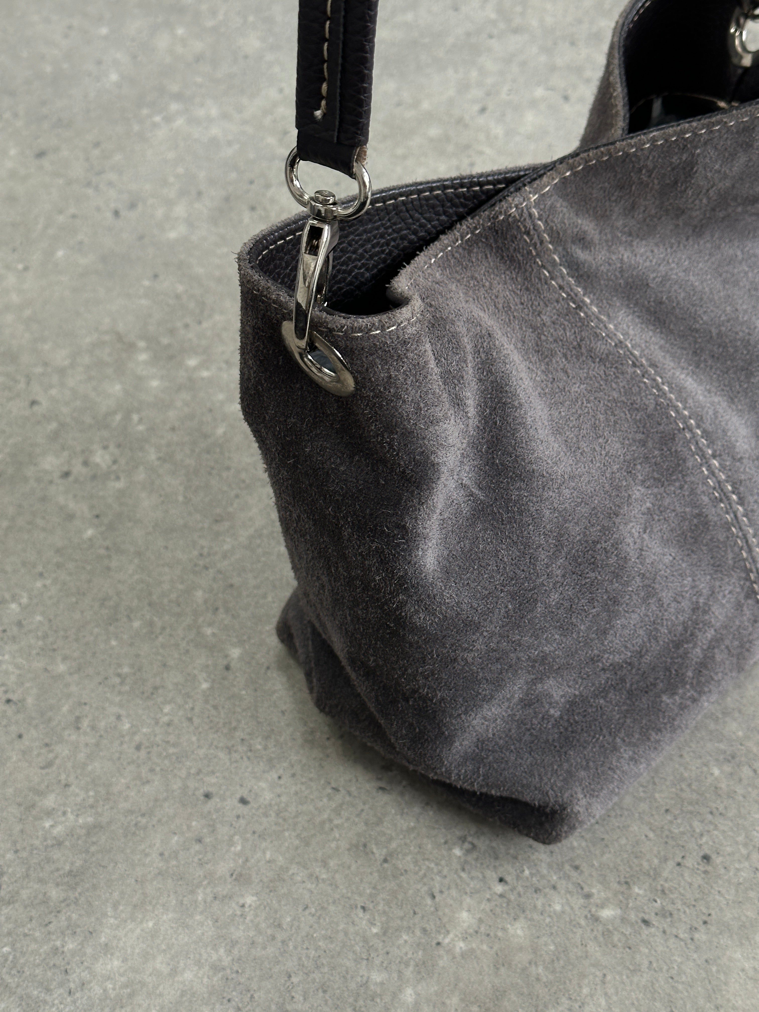 Vintage suede leather shoulder bag with a classic design, featuring a flap closure and adjustable strap.