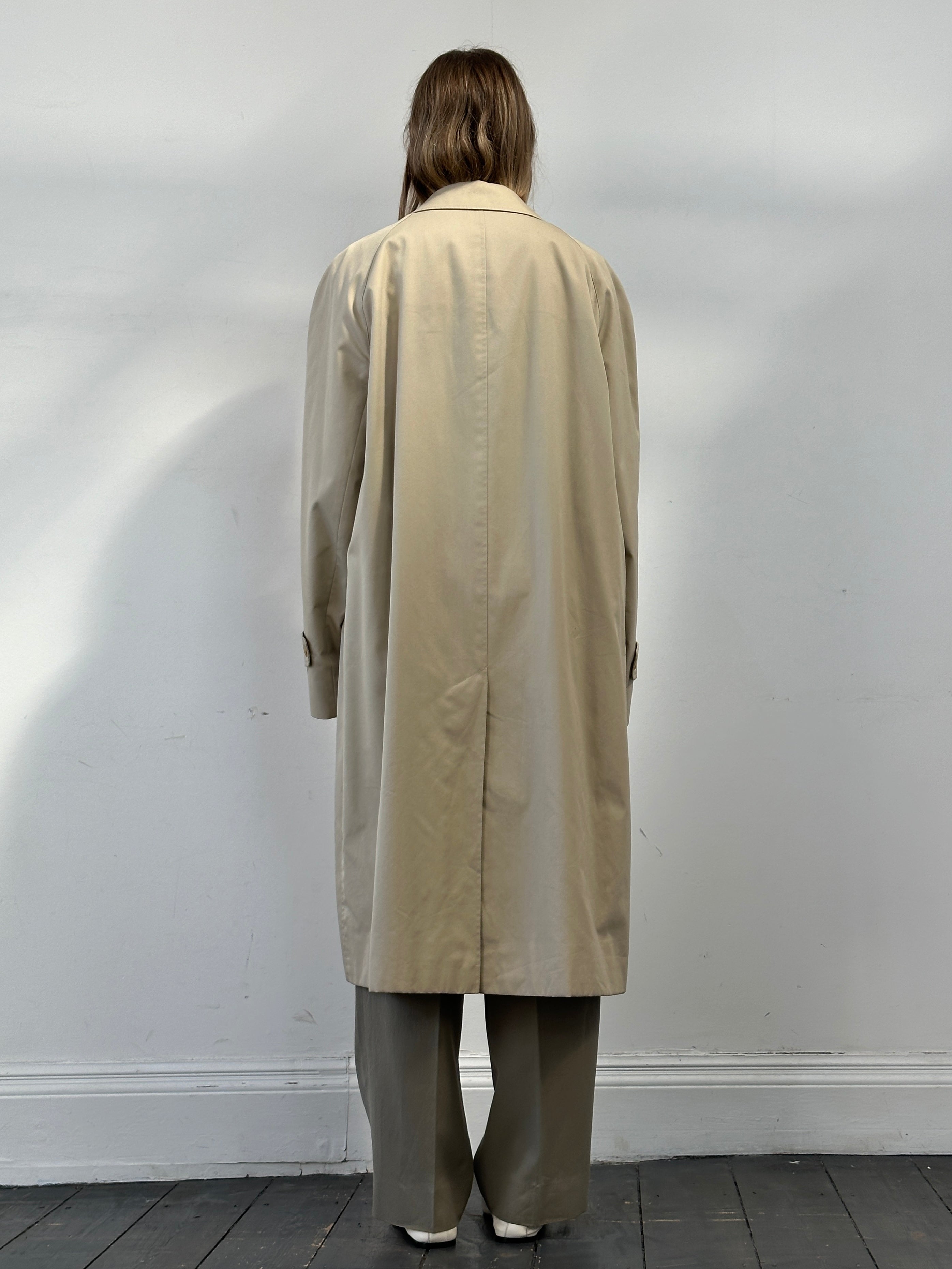 Aquascutum XXL cotton trench coat with concealed placket, classic design, beige color, shown hanging on a wooden hanger.