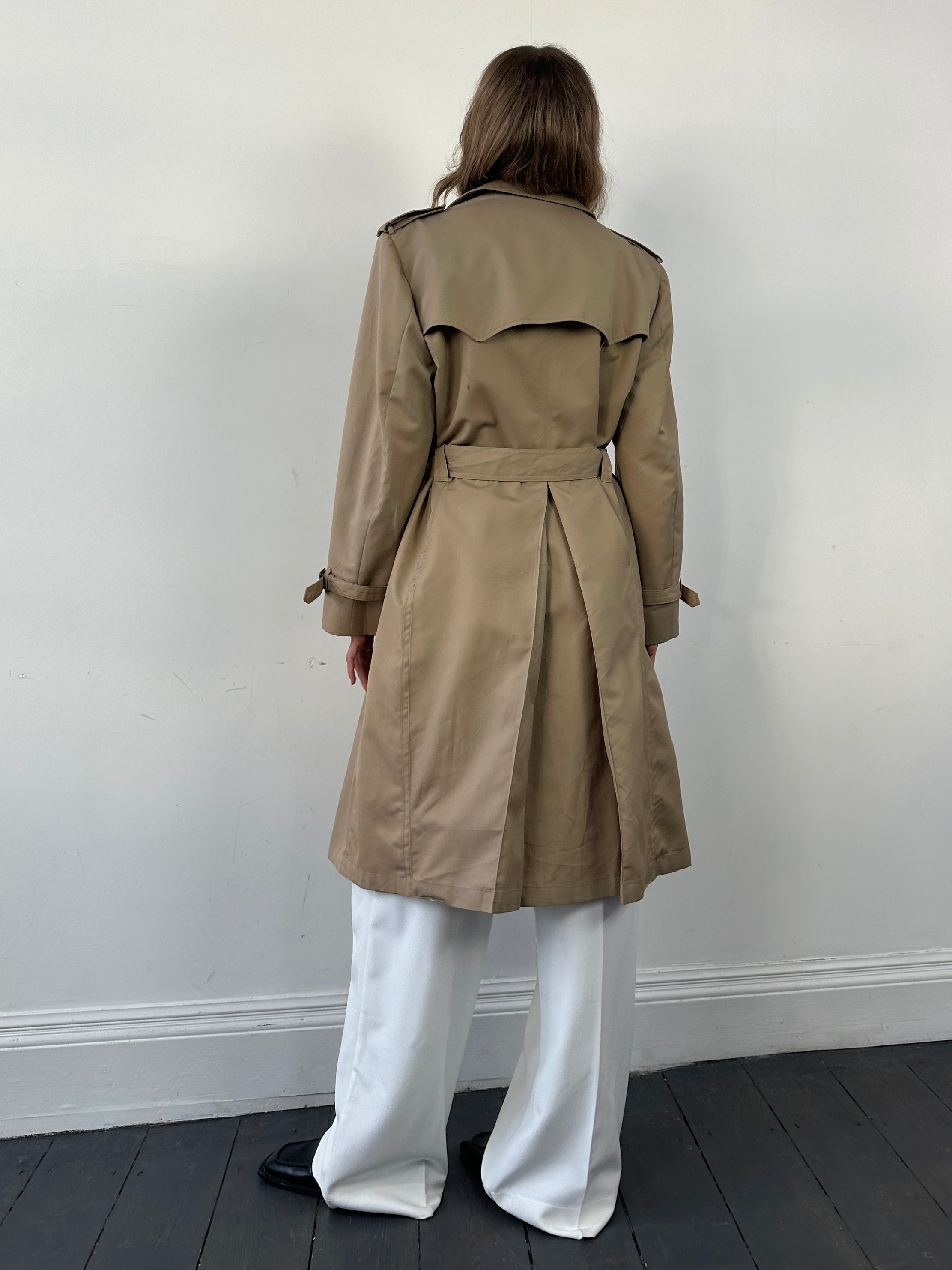 Christian Dior double-breasted cotton trench coat with belt, shown on model in neutral background, stylish and sophisticated fashion.