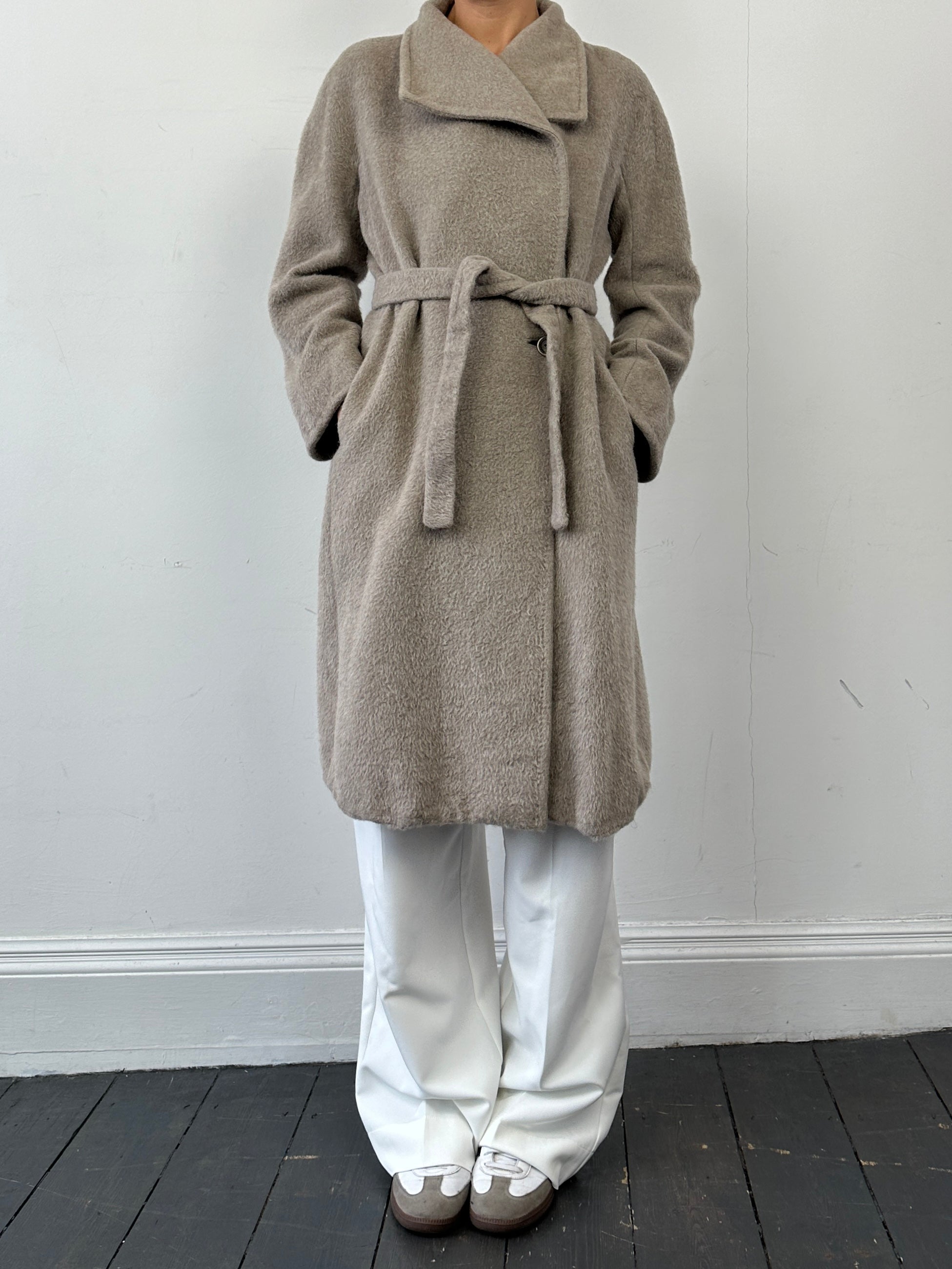 Max Mara alpaca wool belted wrap coat in neutral color, displayed on a hanger, showcasing its elegant design and soft fabric.