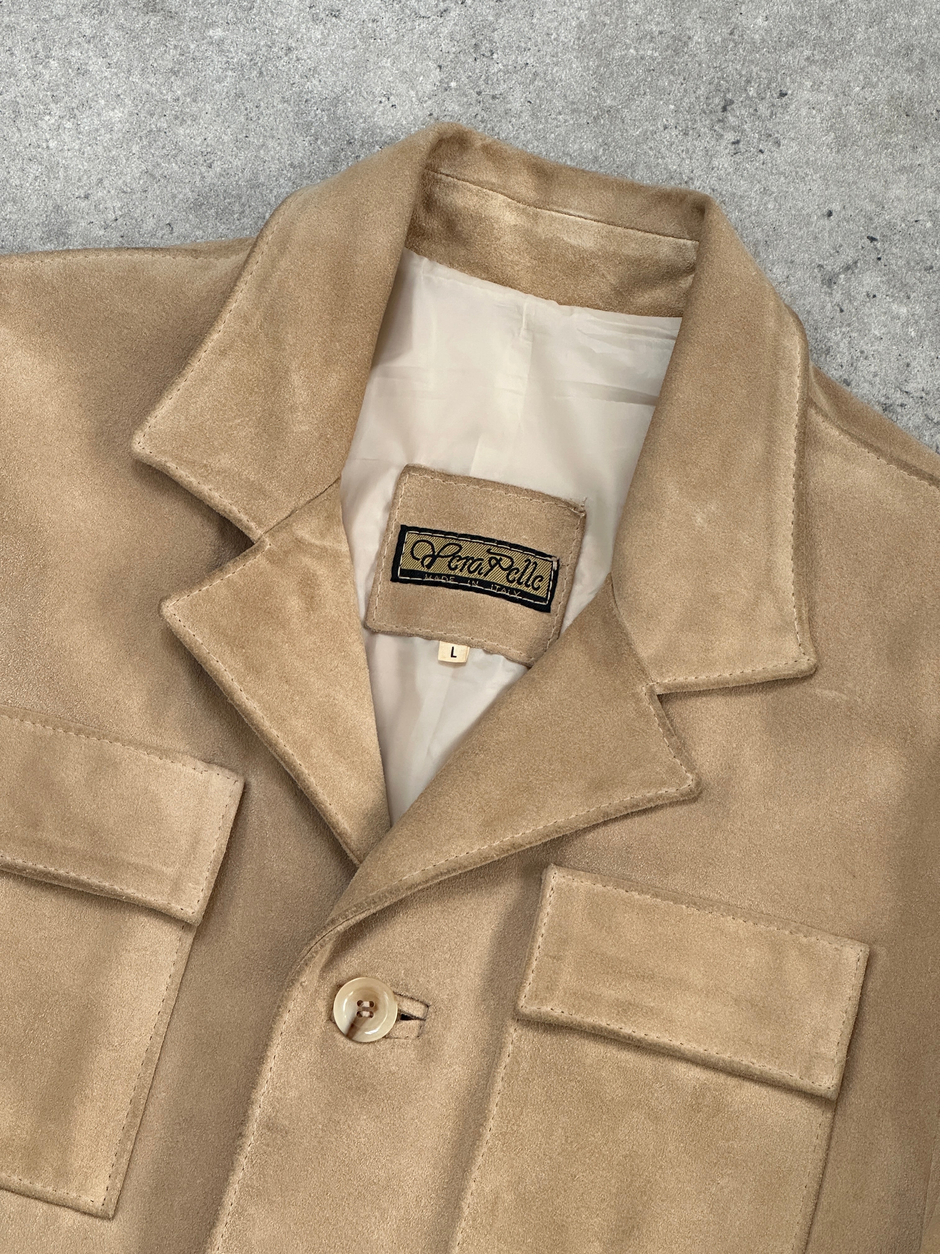 Italian vintage suede jacket in size large, featuring classic design and soft texture, displayed on a hanger against a neutral background.