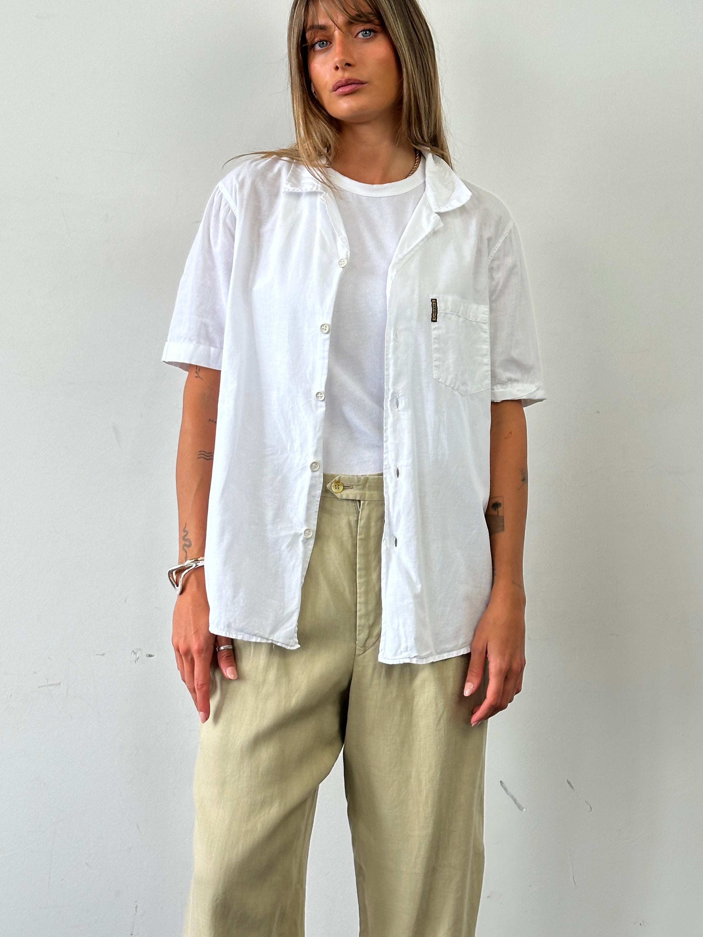 Armani Jeans cotton linen short sleeve logo shirt in M/L displayed on a hanger, featuring a casual fit and subtle branding.