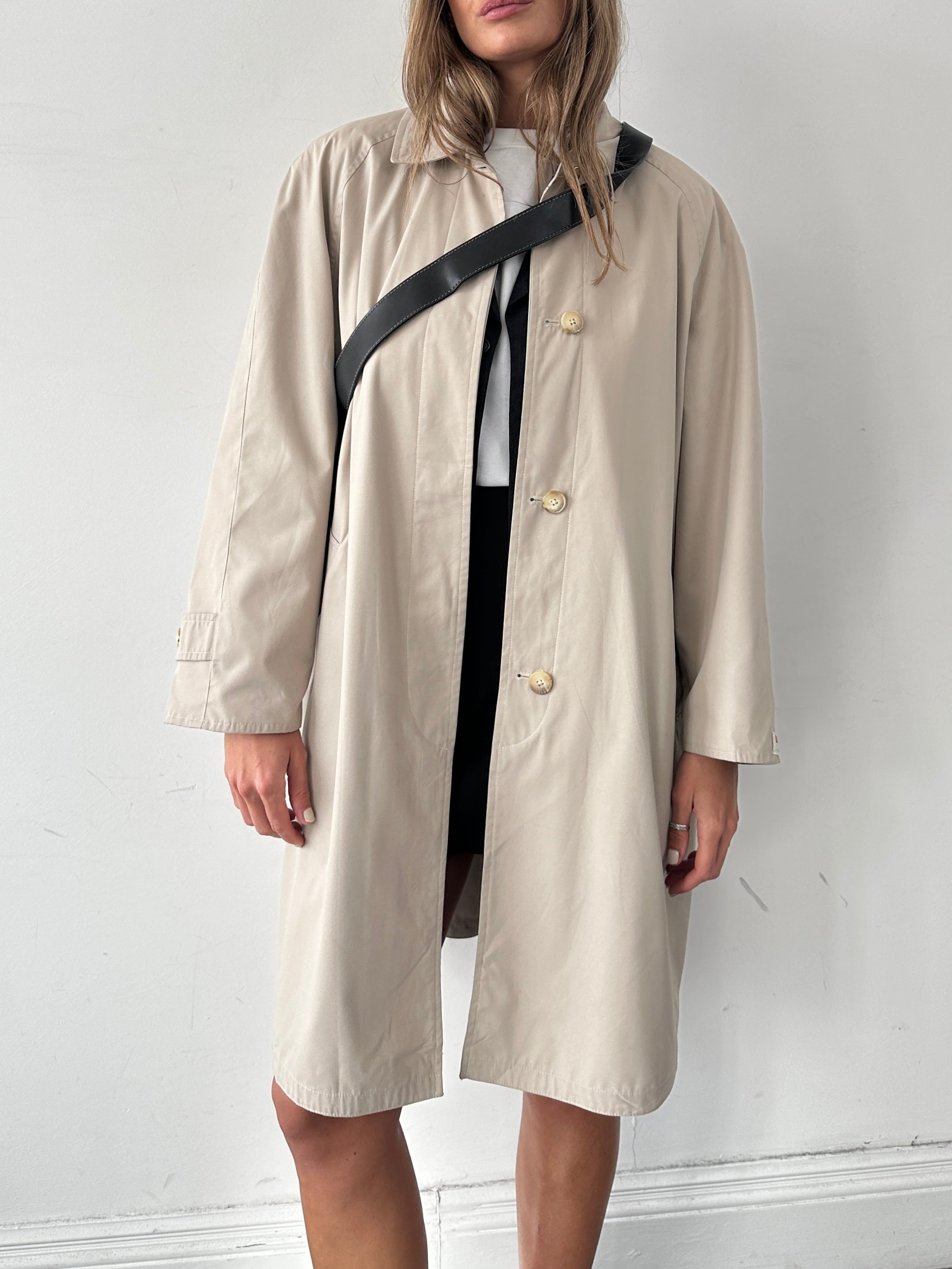 Vintage showerproof reversible trench coat in size M, showing a classic design with a button-up front and reversible fabric.