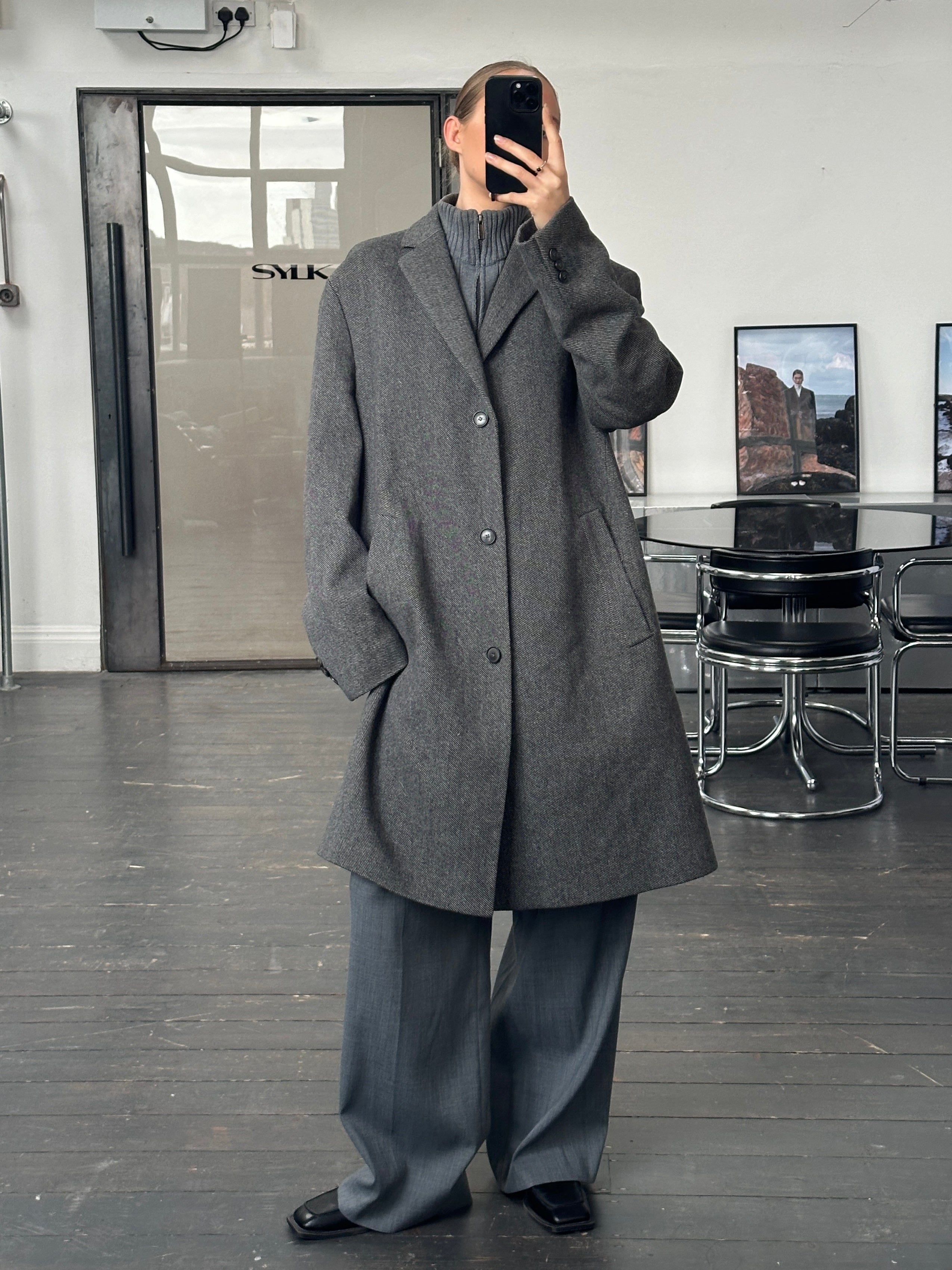 Hugo Boss 1990s wool single-breasted coat in XXL, shown hanging with a classic tailored design and neutral color.
