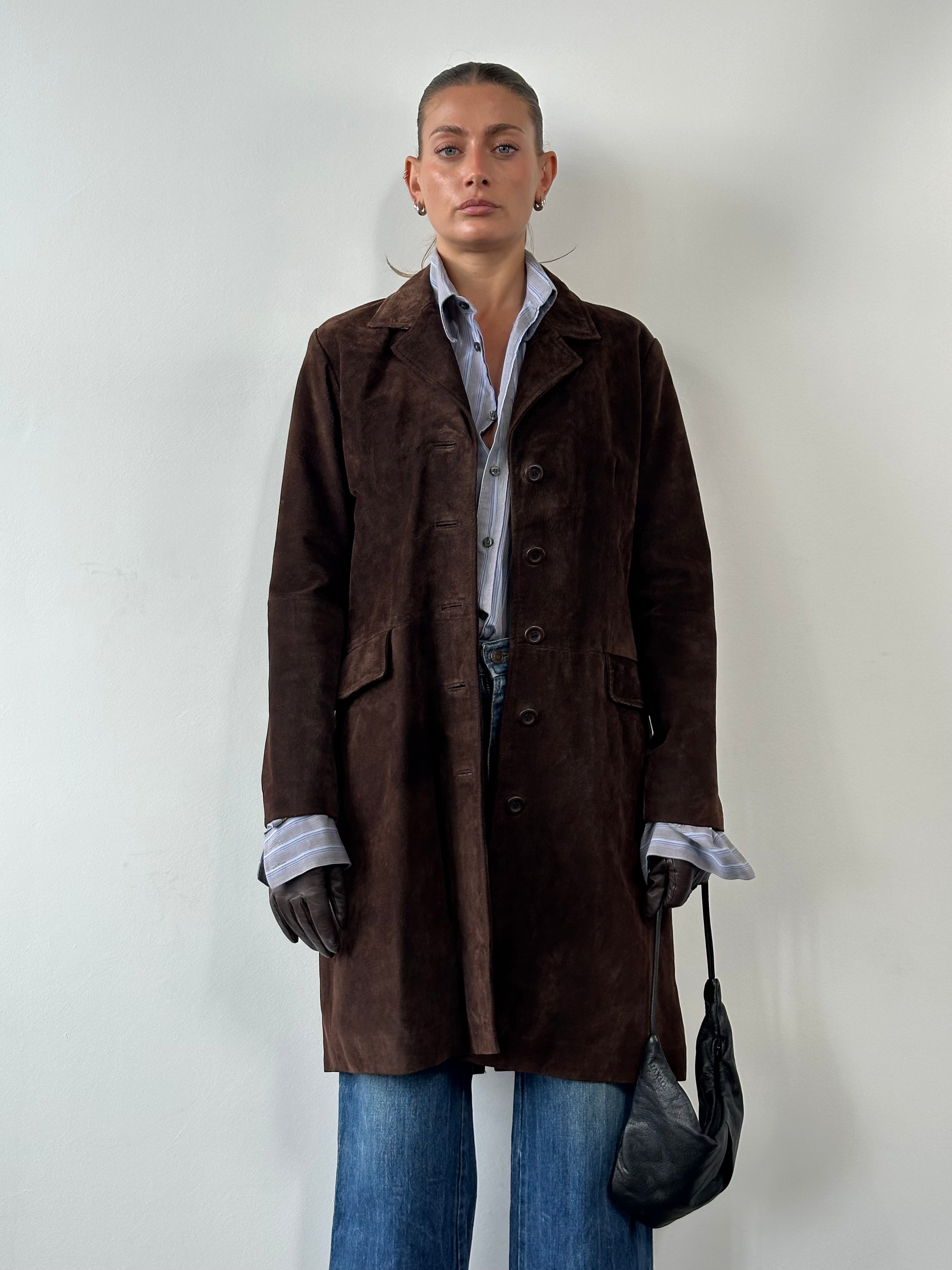 Vintage suede trench coat jacket in size large, featuring classic design and soft texture, shown hanging on a wooden hanger.