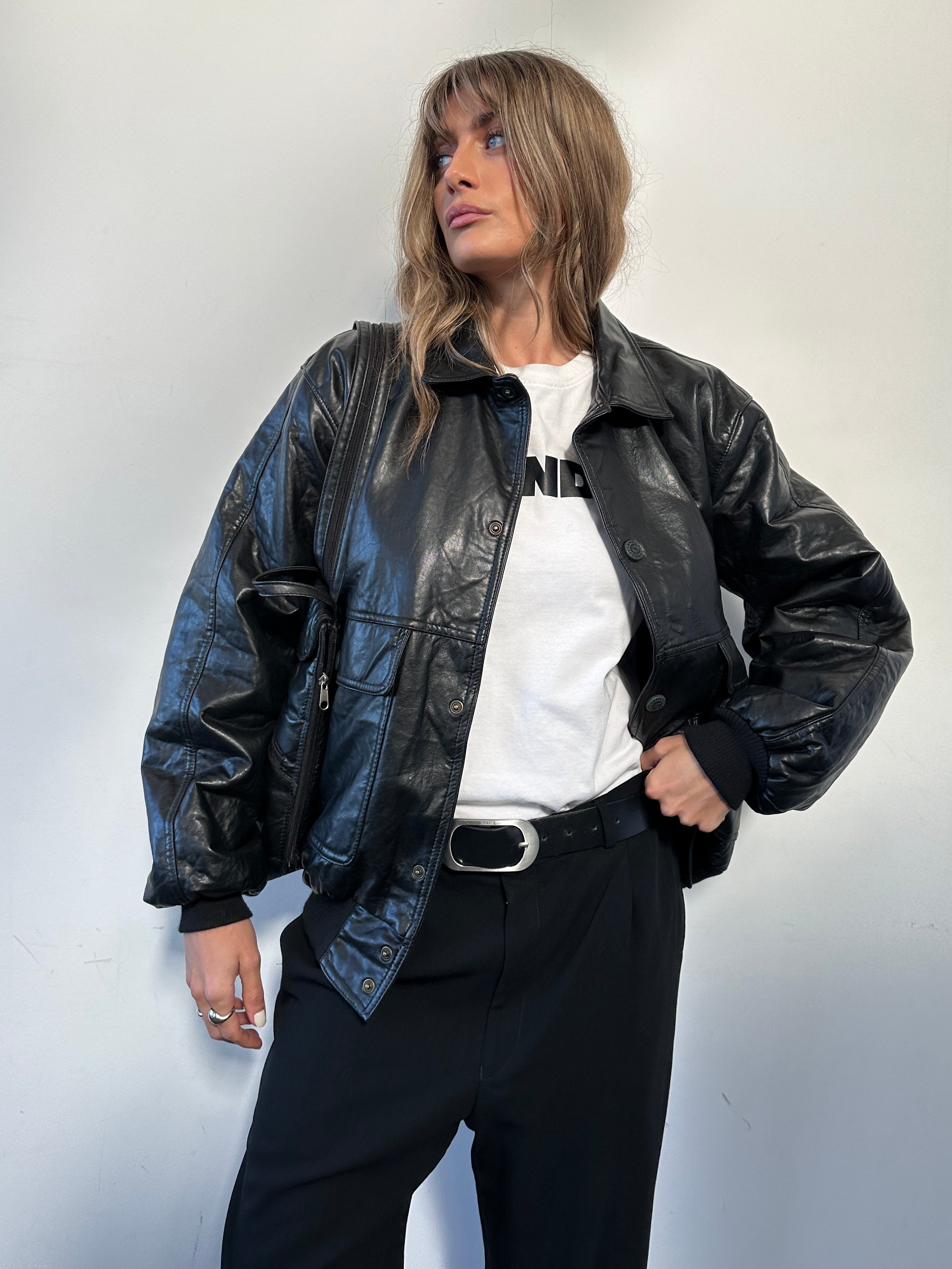 Vintage Italian faux leather bomber jacket in size large, featuring a classic design and stylish detailing.