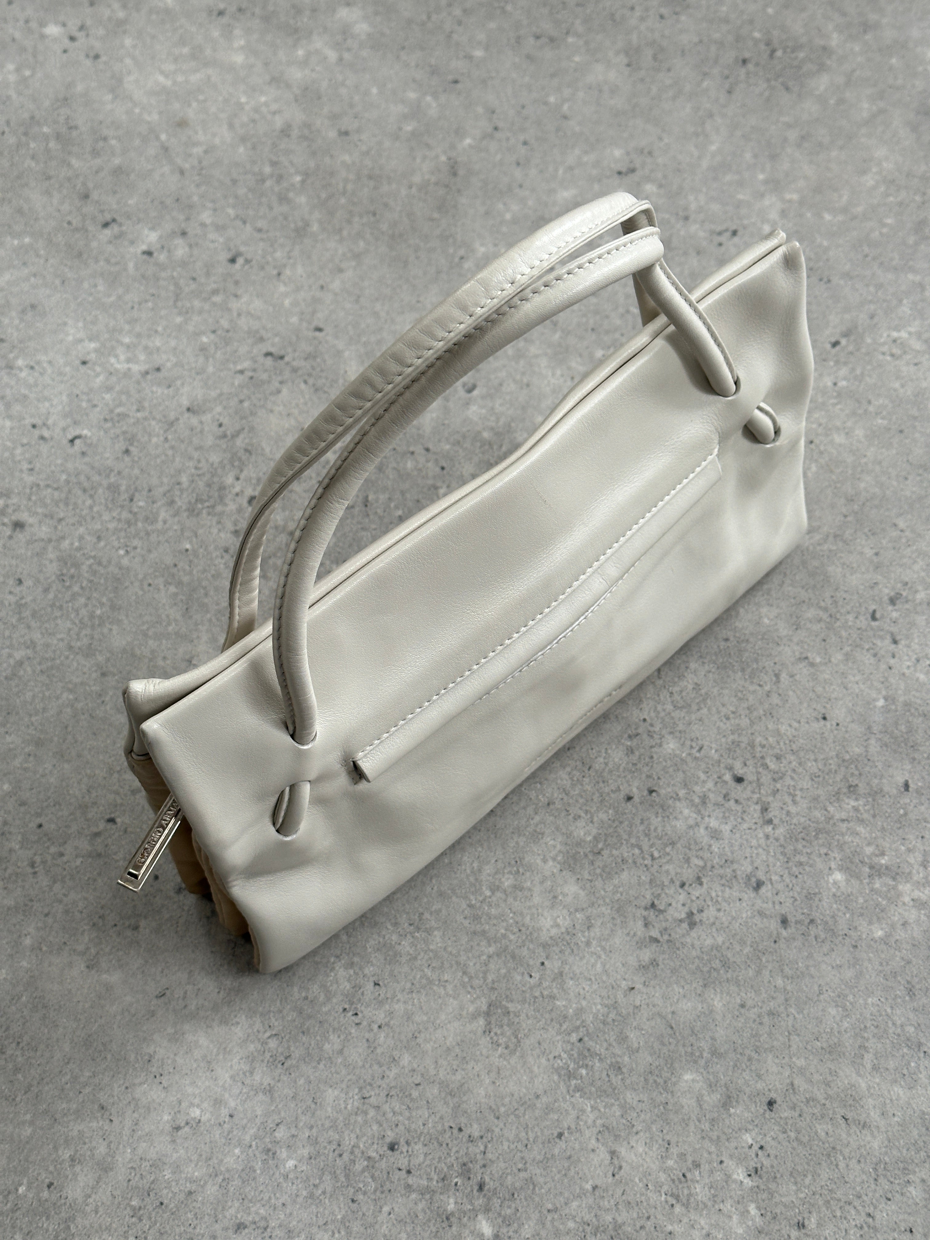 Giorgio Armani Le Collezioni embossed logo handbag with structured shape and top handle, featuring signature Armani branding.
