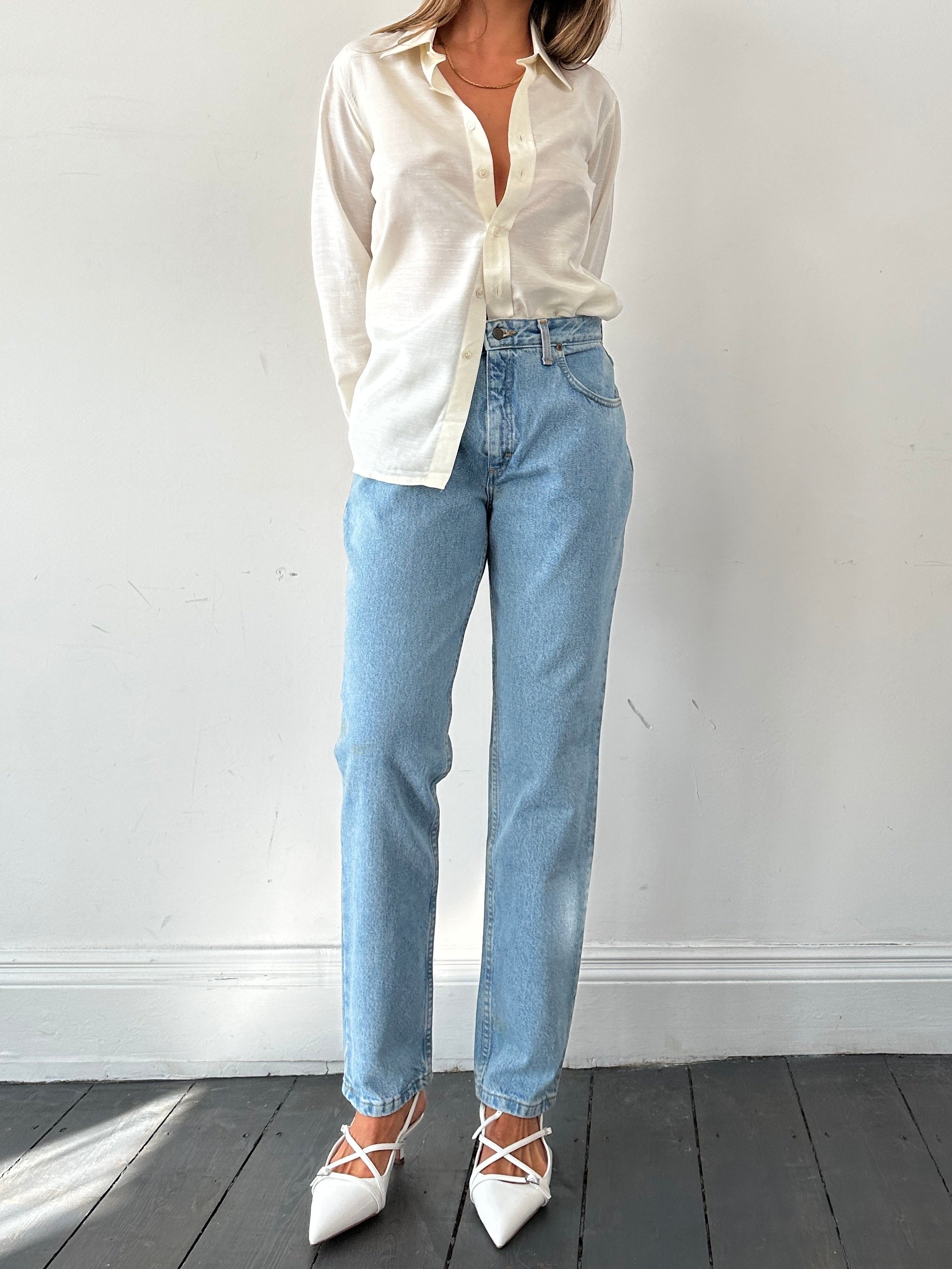 Light wash high-waisted Lee denim jeans with front pockets and classic stitching, displayed flat on a white background.