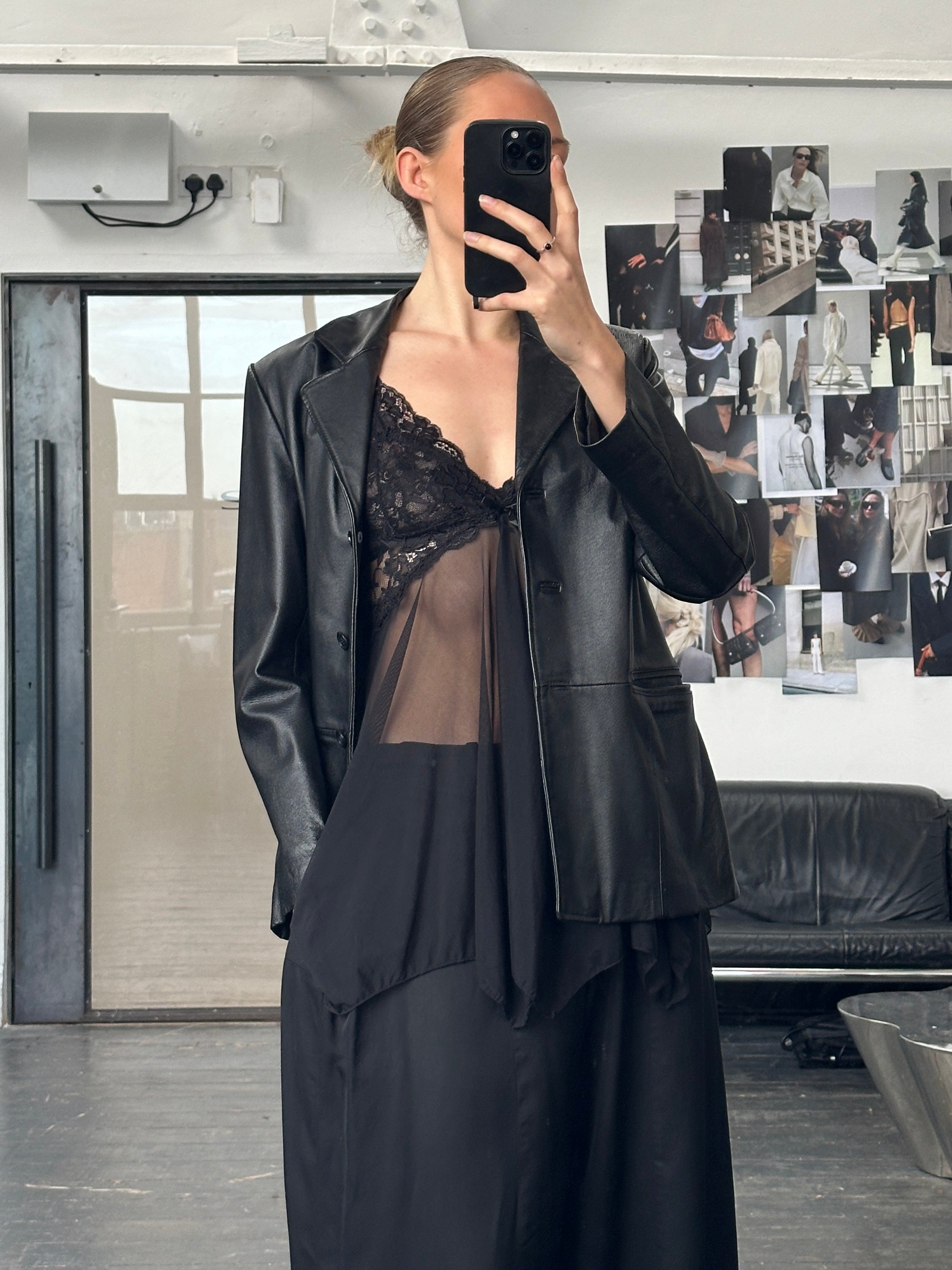 Vintage 1990s minimal leather jacket in size M, featuring sleek design and classic leather texture.