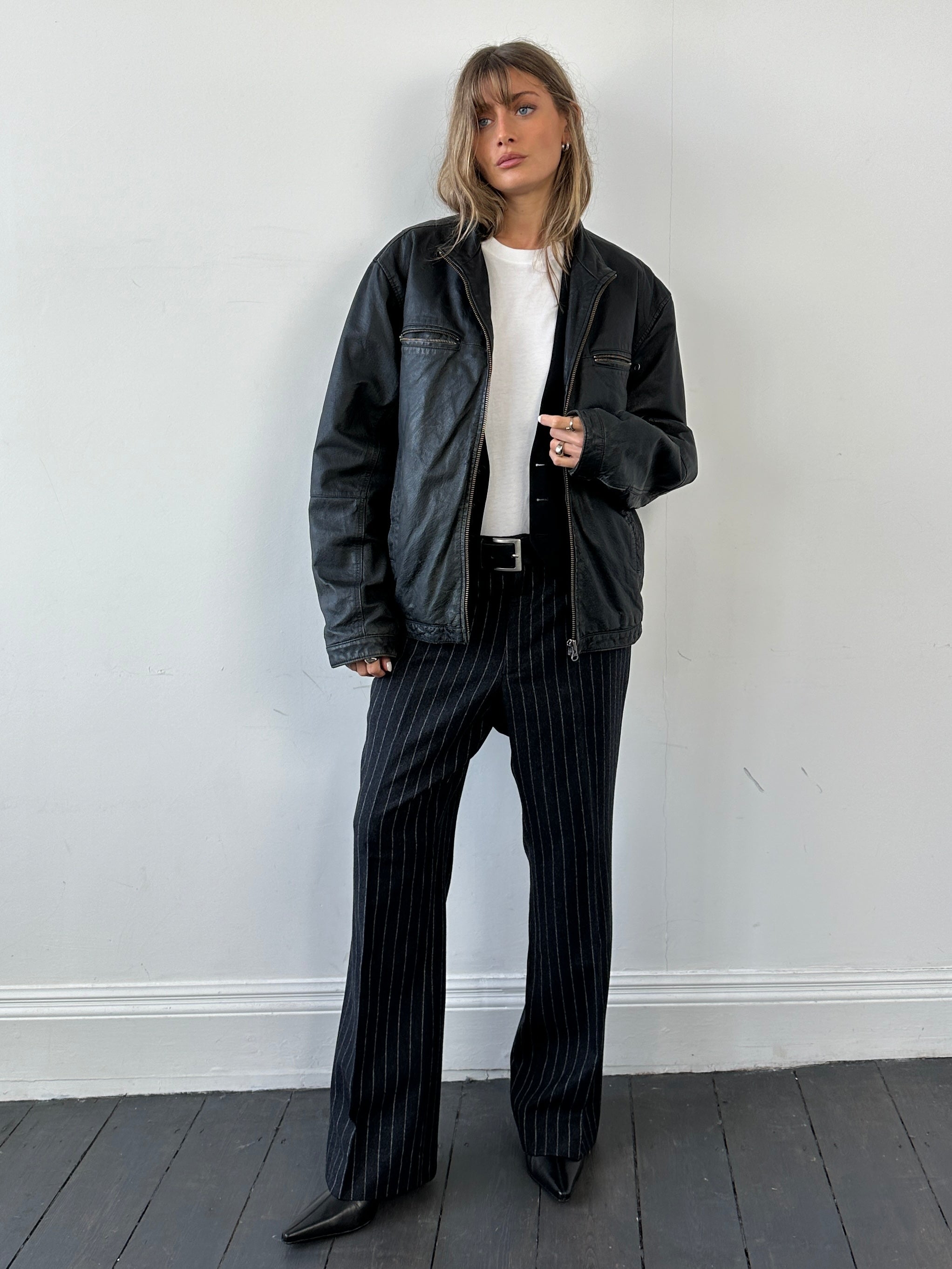 Vintage leather zip-up jacket in size large, featuring classic design, smooth texture, and stylish front zipper.