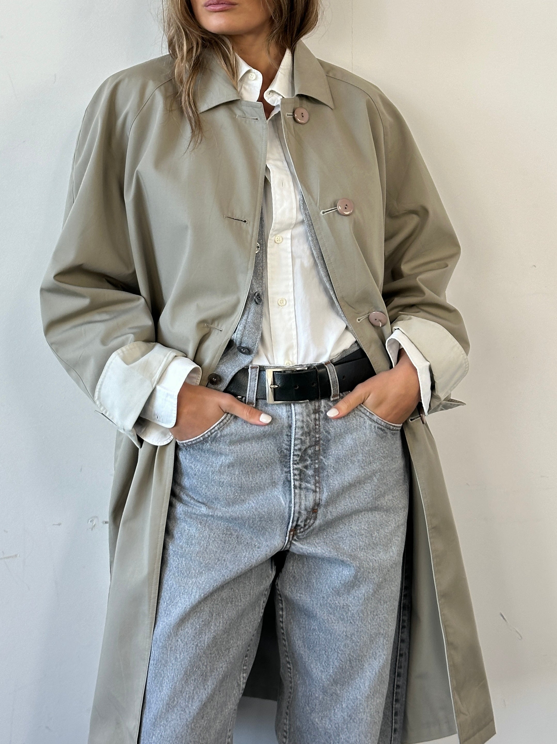 Vintage reversible water-resistant trench coat in size L/XL, showing both classic and modern design on a hanger.