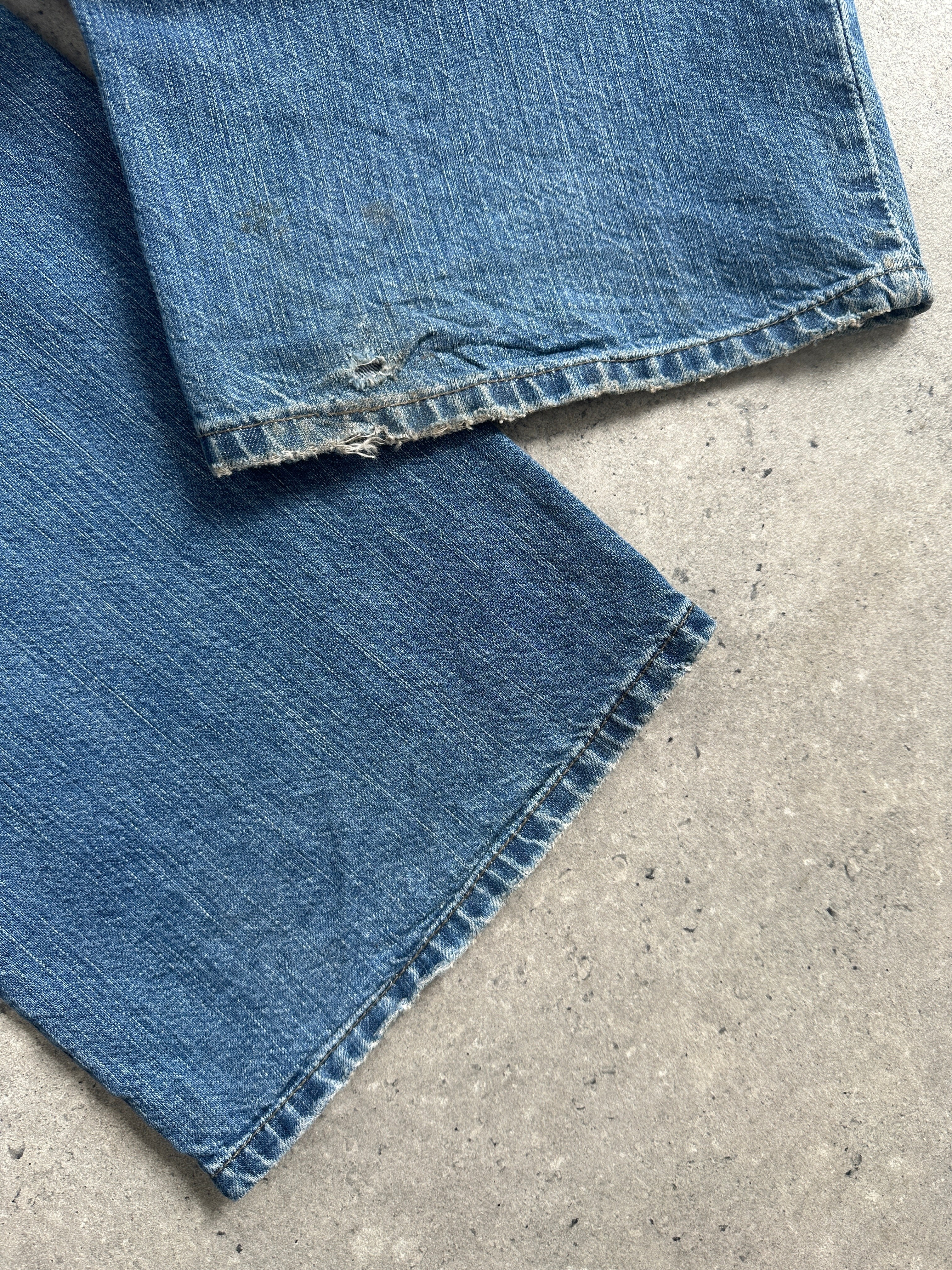 Armani Jeans stonewashed mid-waist denim jeans in size W34, showing classic blue color and relaxed fit on a plain background.