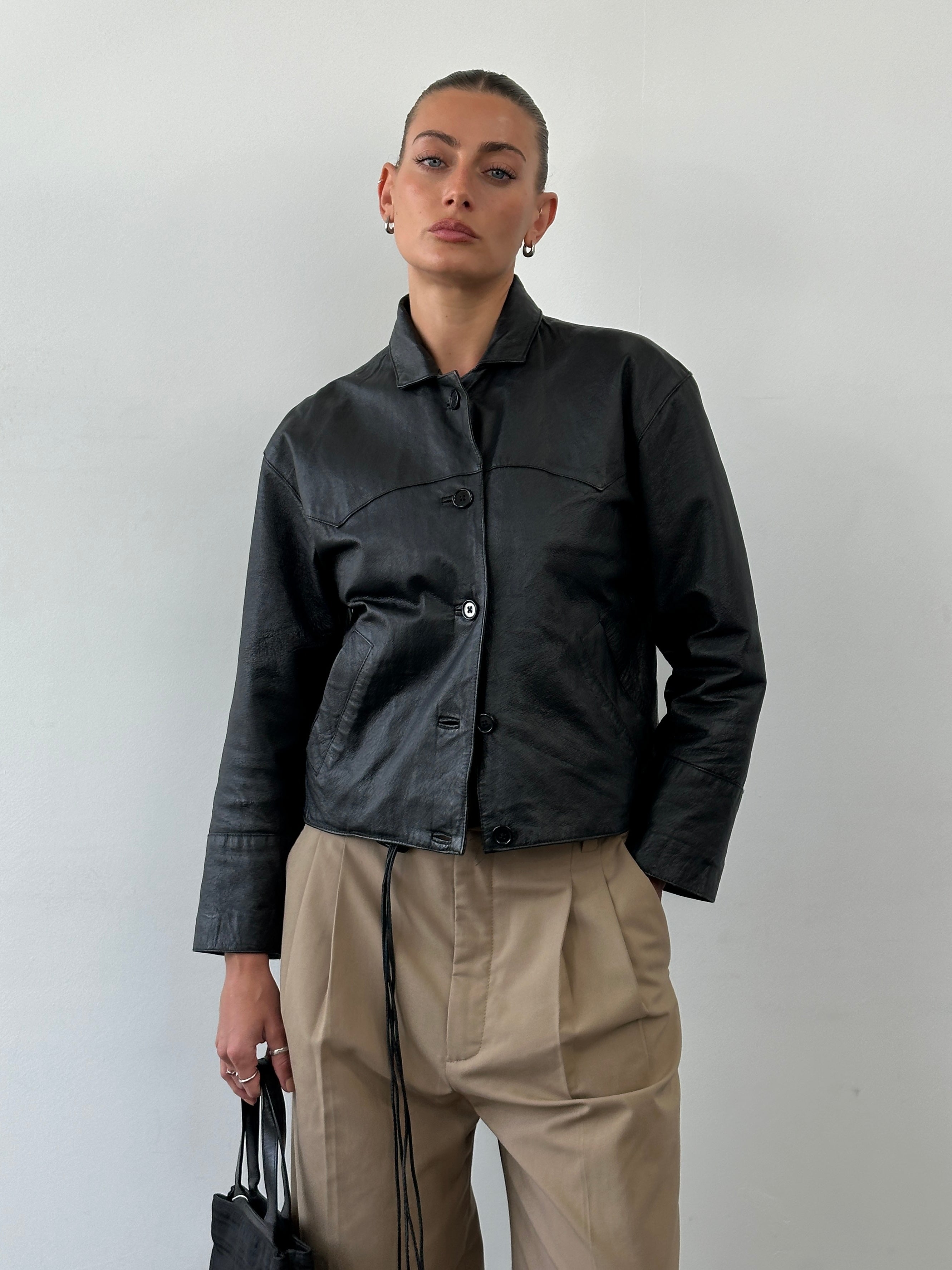 Vintage brand cropped leather jacket in size small, shown in a close-up image highlighting the textured leather and stylish fit.