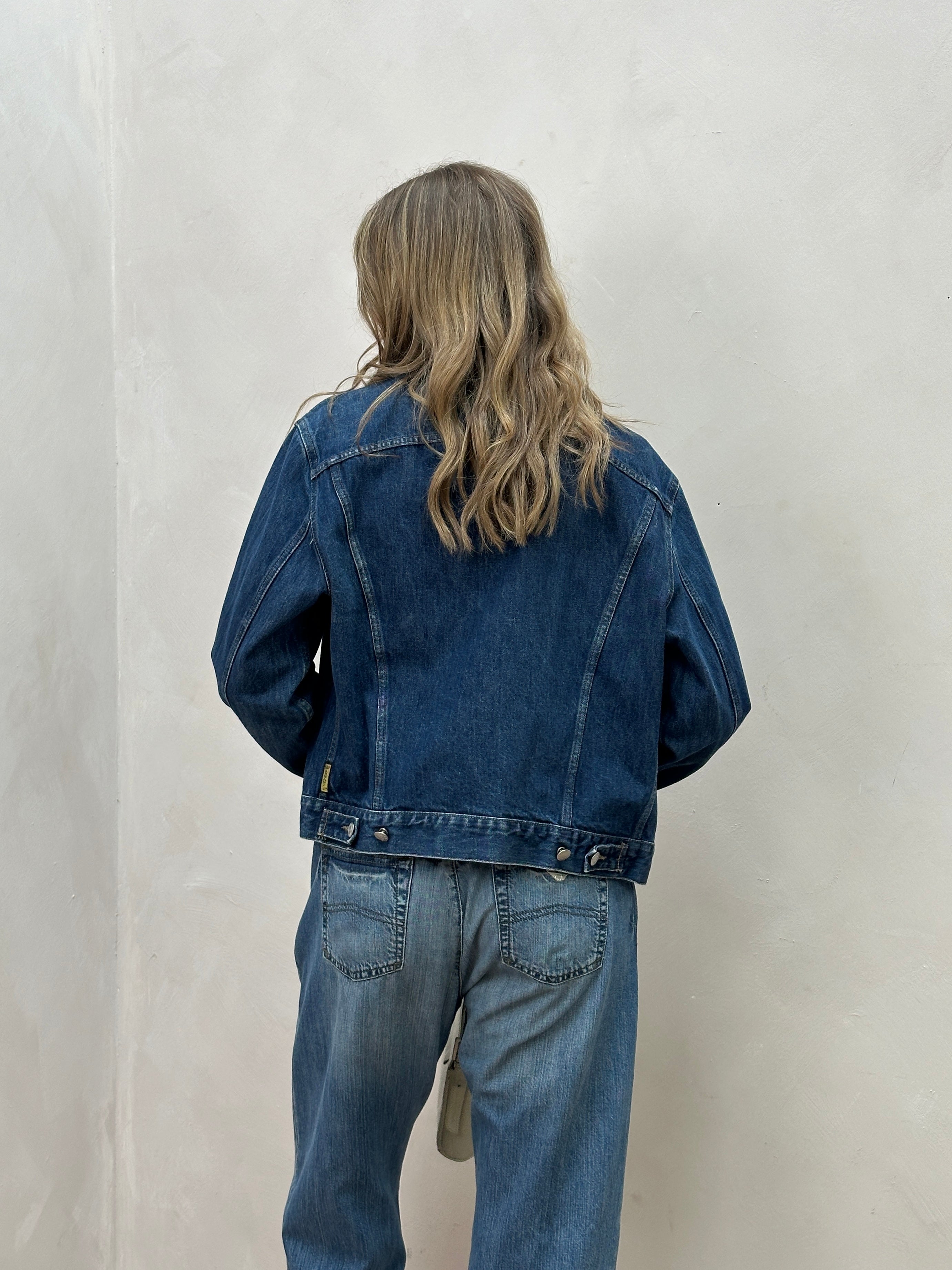 Armani Jeans mid wash denim jacket in size S/M, featuring classic design with visible stitching and button closures.