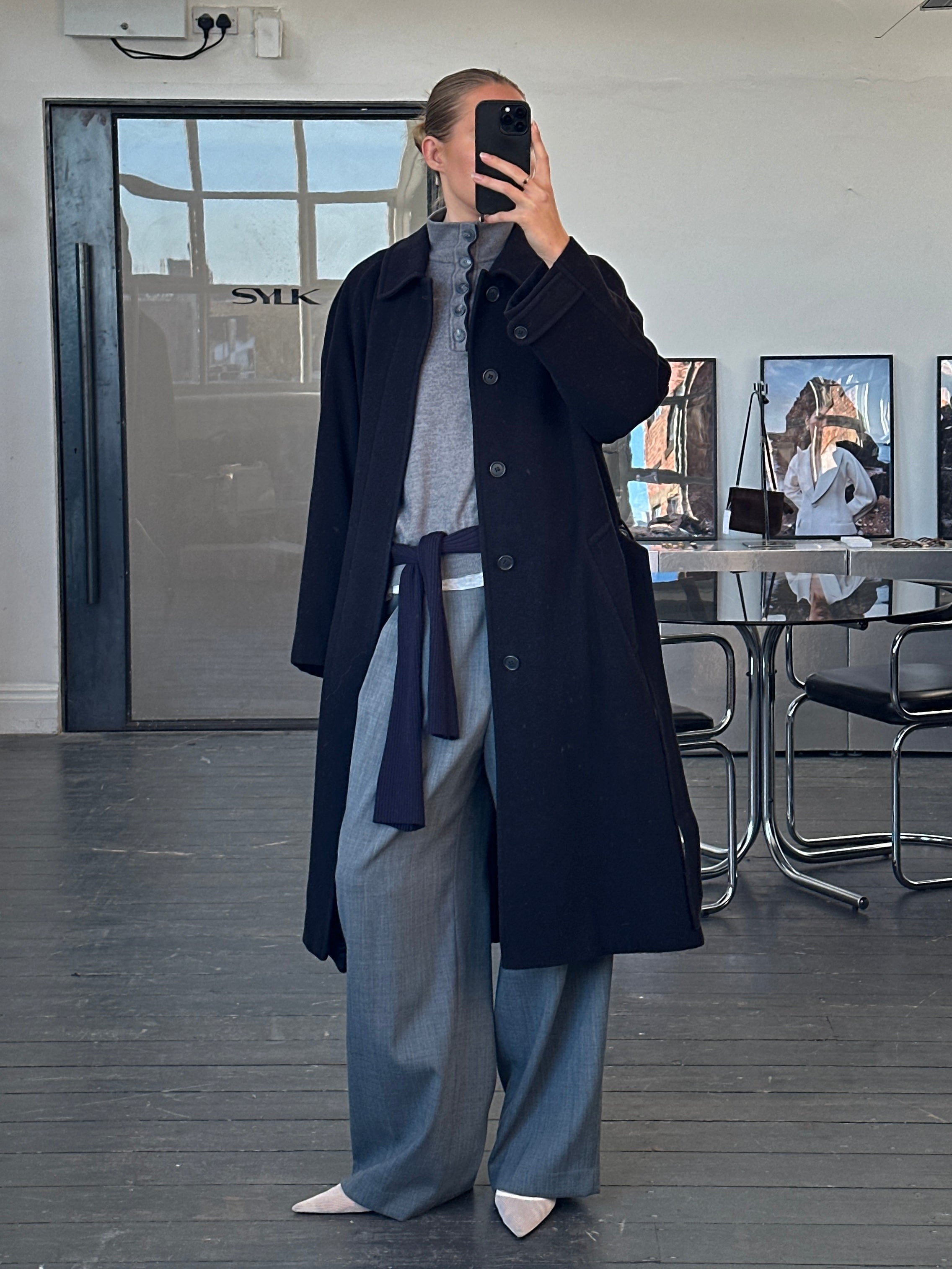 Vintage 1990s wool and cashmere belted coat in size L/XL, featuring a classic design and warm, textured fabric.