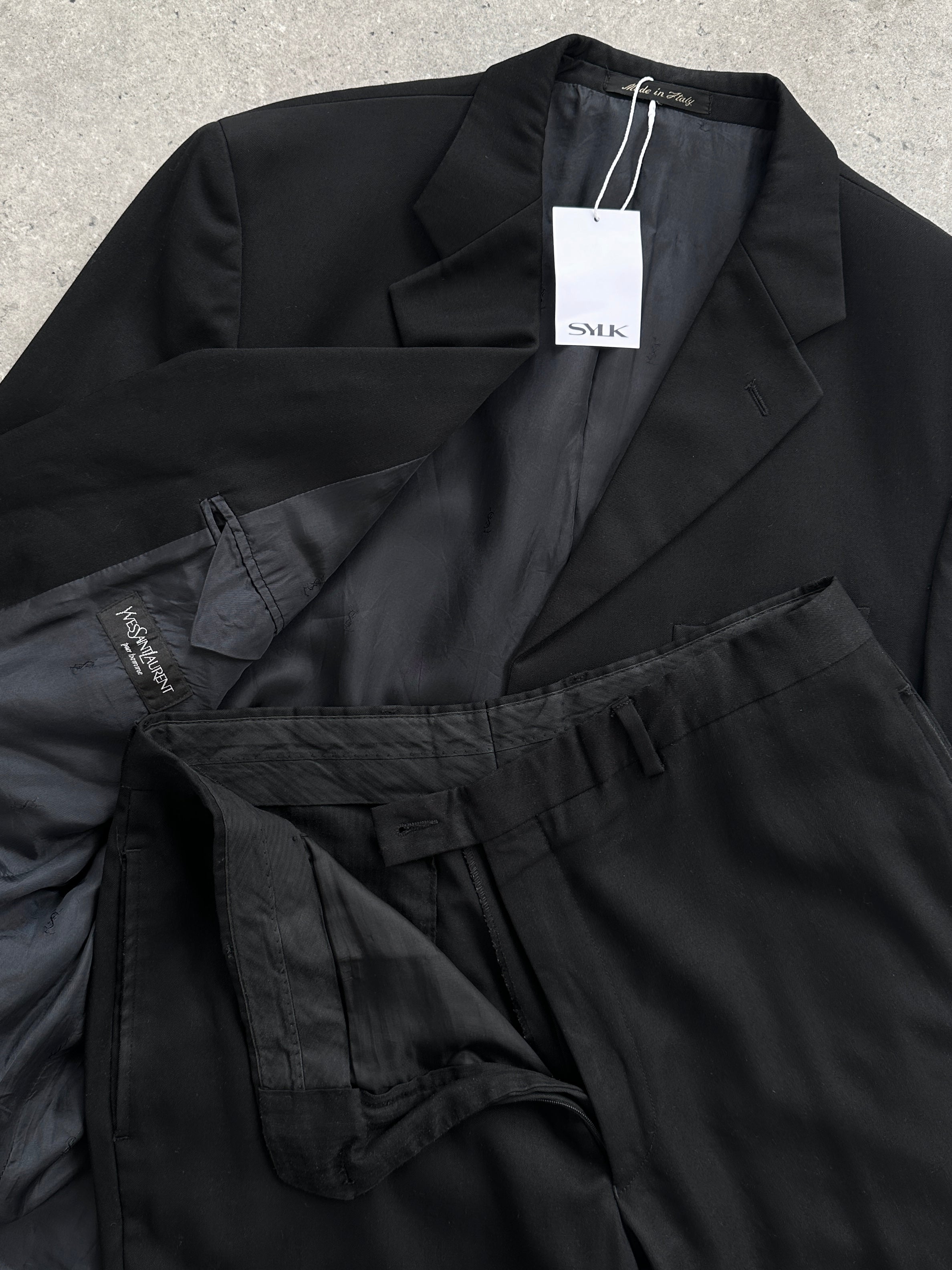 Yves Saint Laurent Pour Homme pure wool single-breasted suit in size 42R/W34, tailored fit, navy blue fabric, displayed on a hanger.