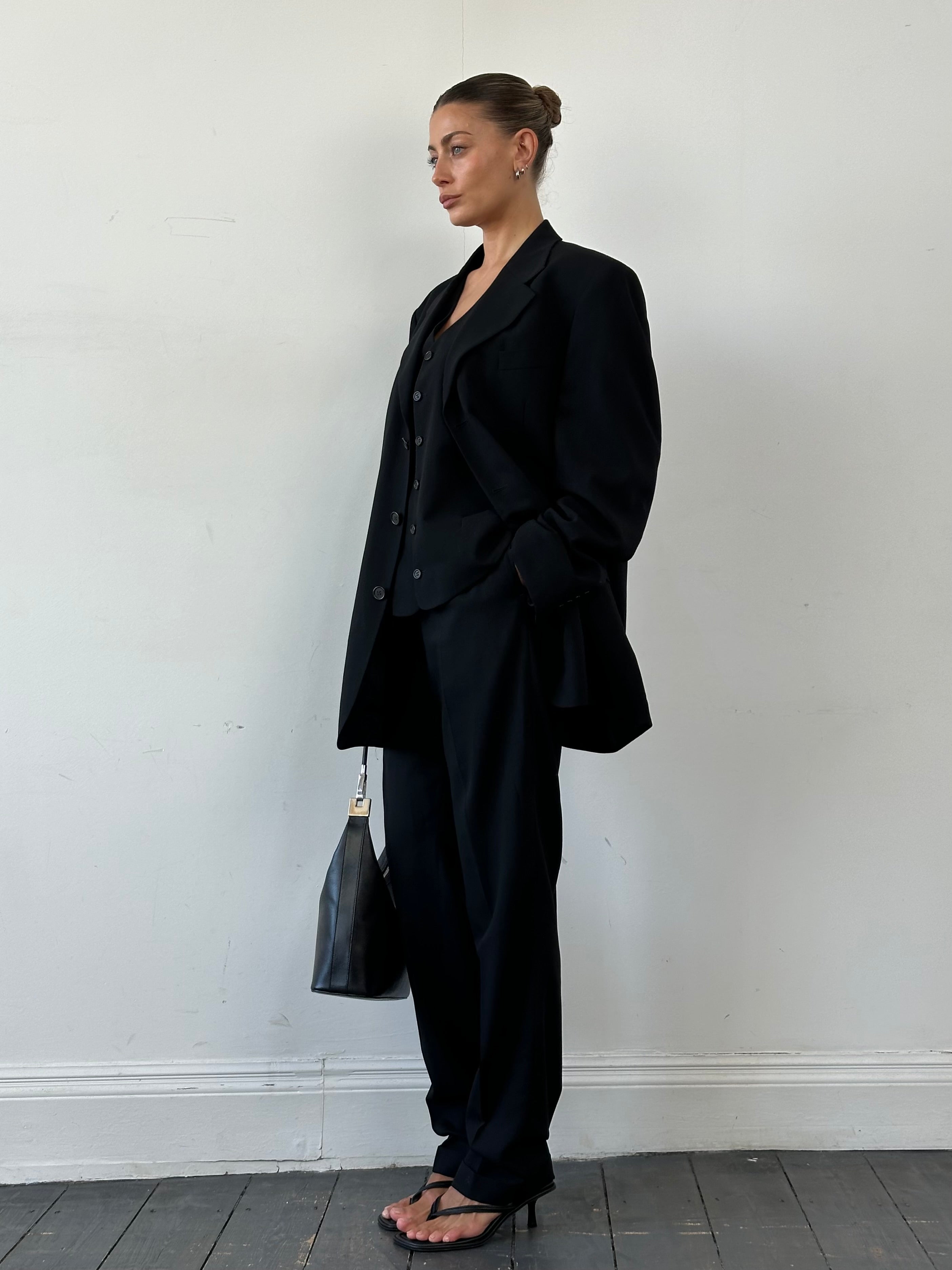 Yves Saint Laurent Pour Homme pure wool three-piece suit in size 46L/W34, displayed on a hanger showing jacket, vest, and trousers.