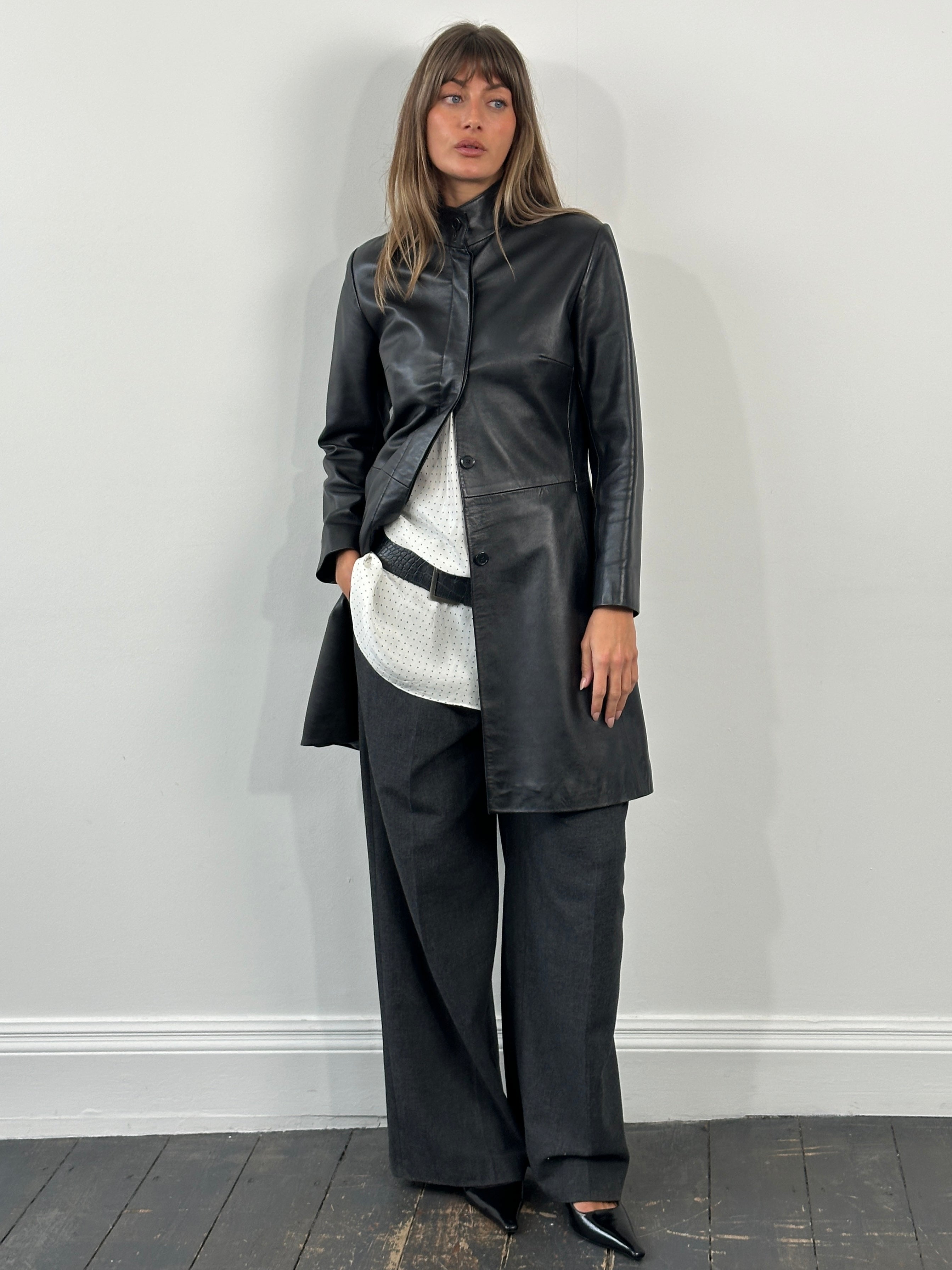 Vintage 1990s minimal high neck leather trench coat in size small, featuring sleek design and classic black leather finish.