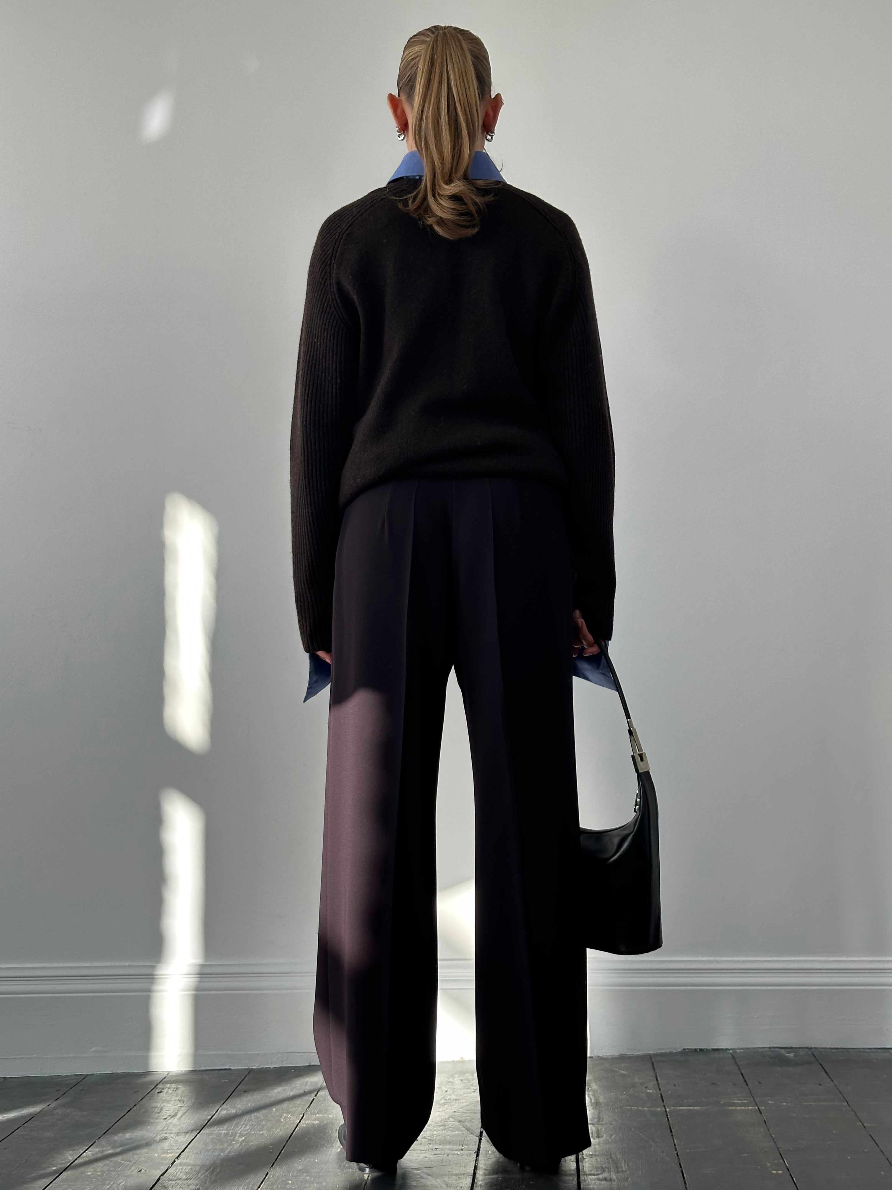 Max Mara minimal wide leg trousers in W32, shown in a neutral color, displayed on a hanger with a plain background.