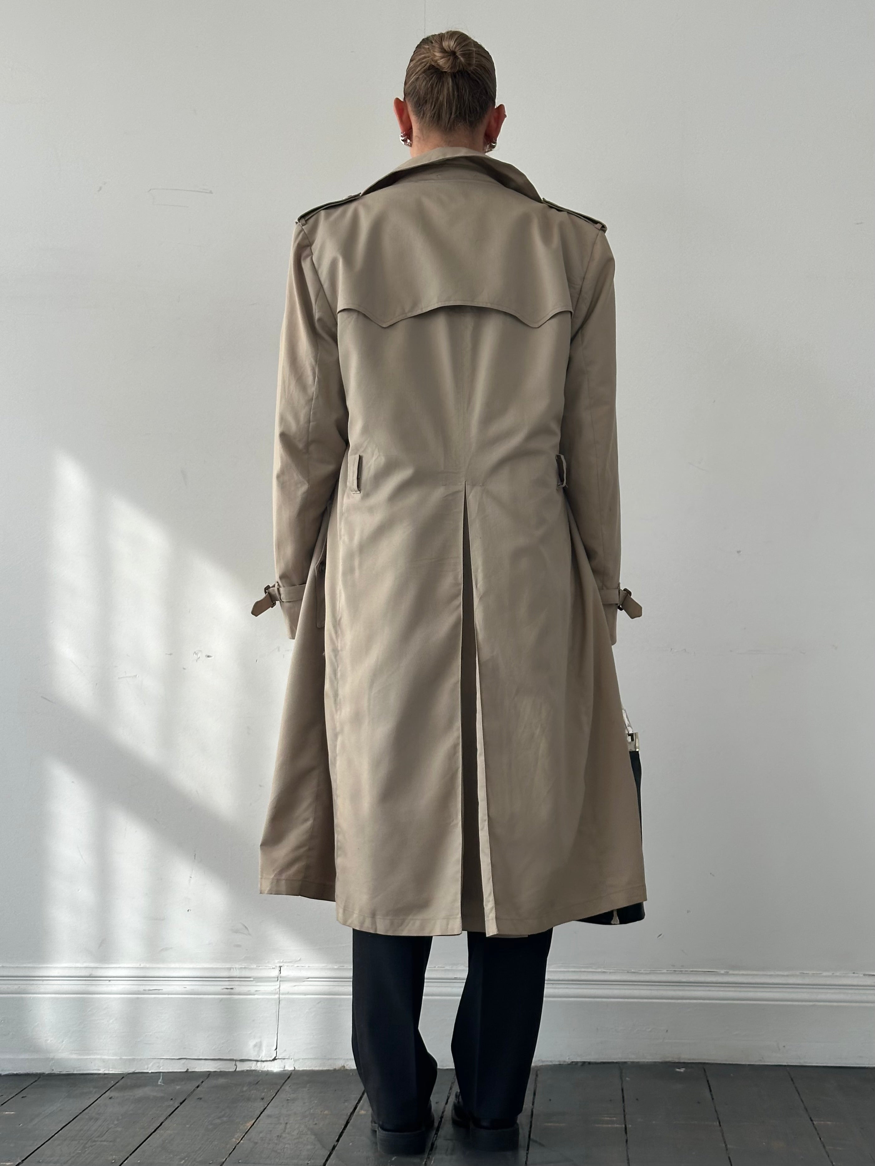 Christian Dior double-breasted trench coat in XL/XXL, showing classic beige fabric, belted waist, and stylish lapel design.