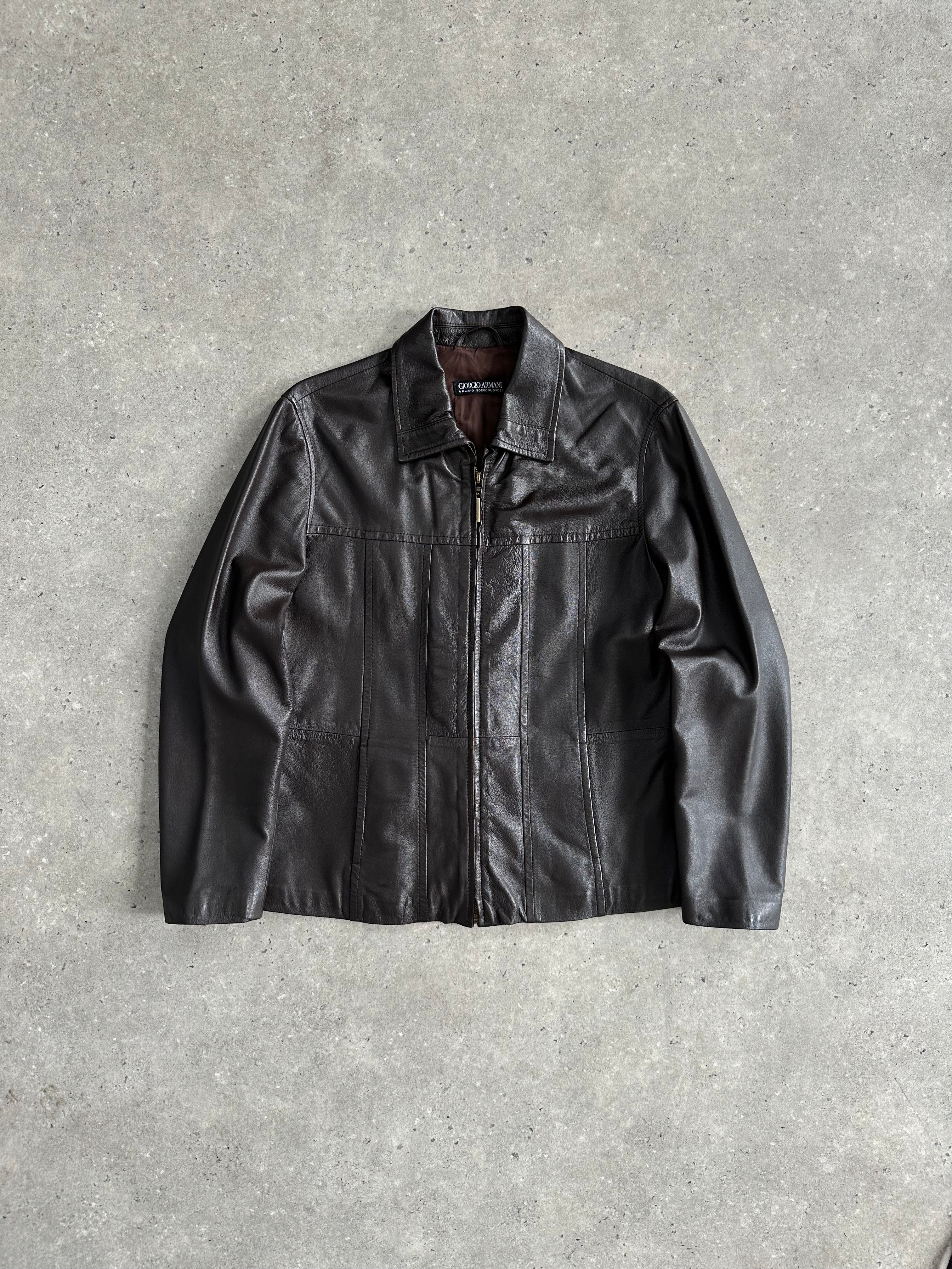 Giorgio Armani Black Label belted leather jacket in black, featuring a sleek design and silver buckle, displayed on a hanger.