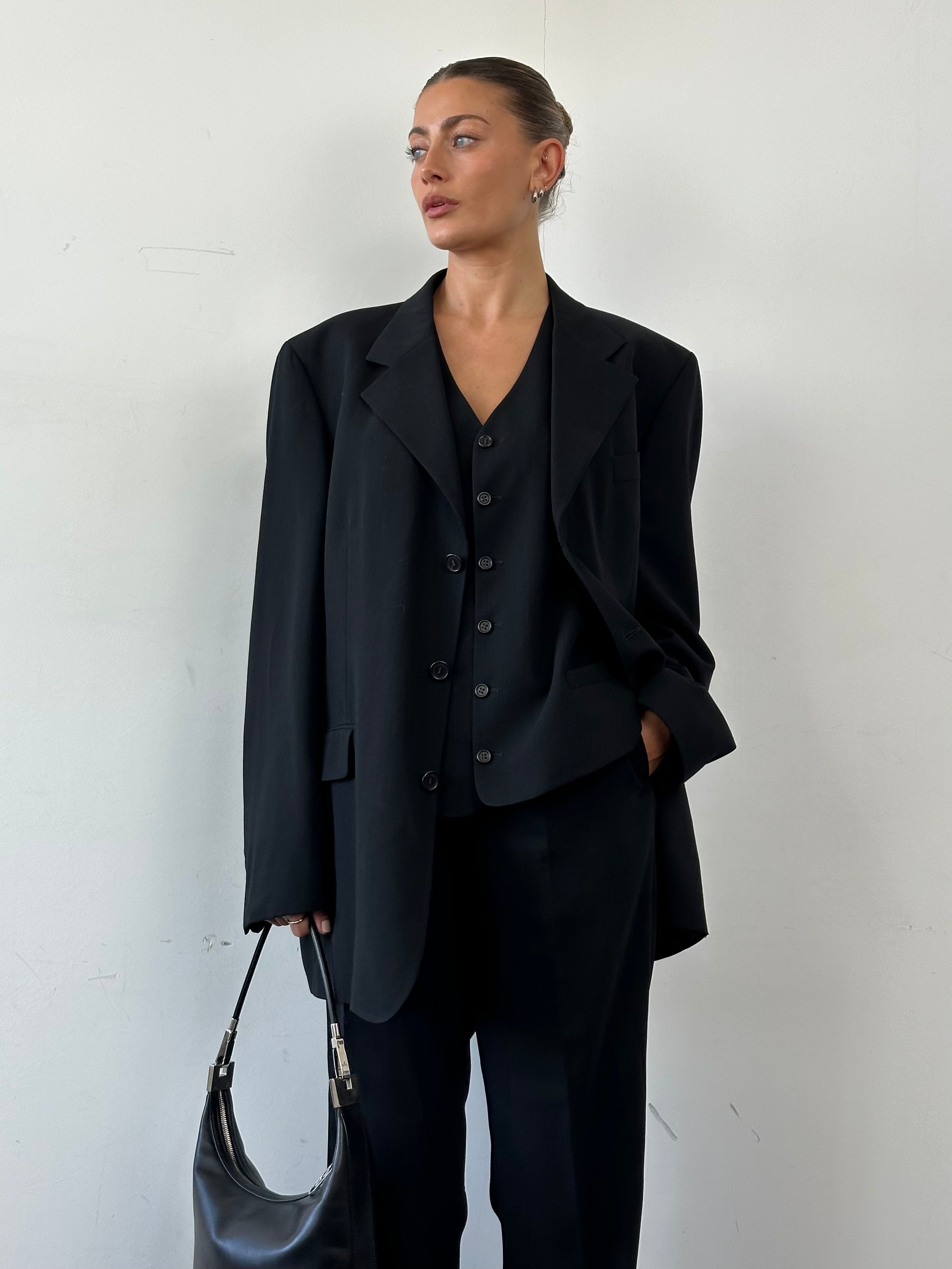 Yves Saint Laurent Pour Homme three-piece wool suit in size 46L/W34, tailored with a classic fit, featuring a jacket, vest, and trousers.