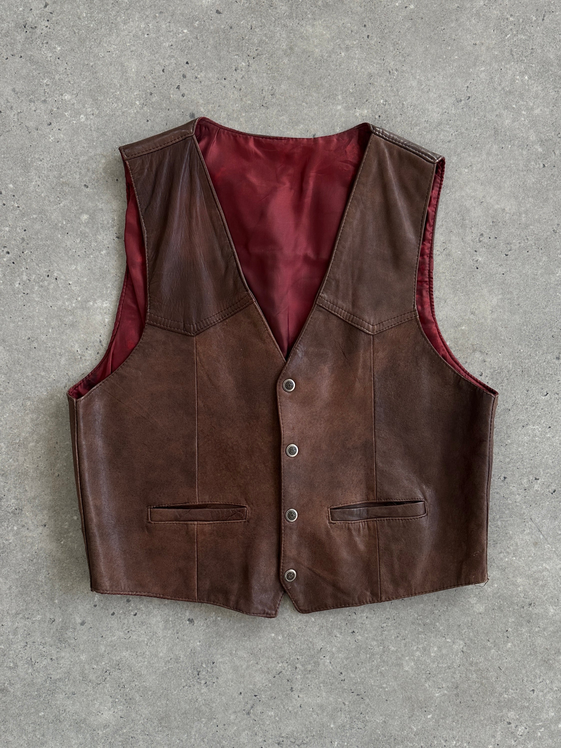 Vintage Italian vintage aged leather waistcoat in size large, featuring distressed leather and classic design details.