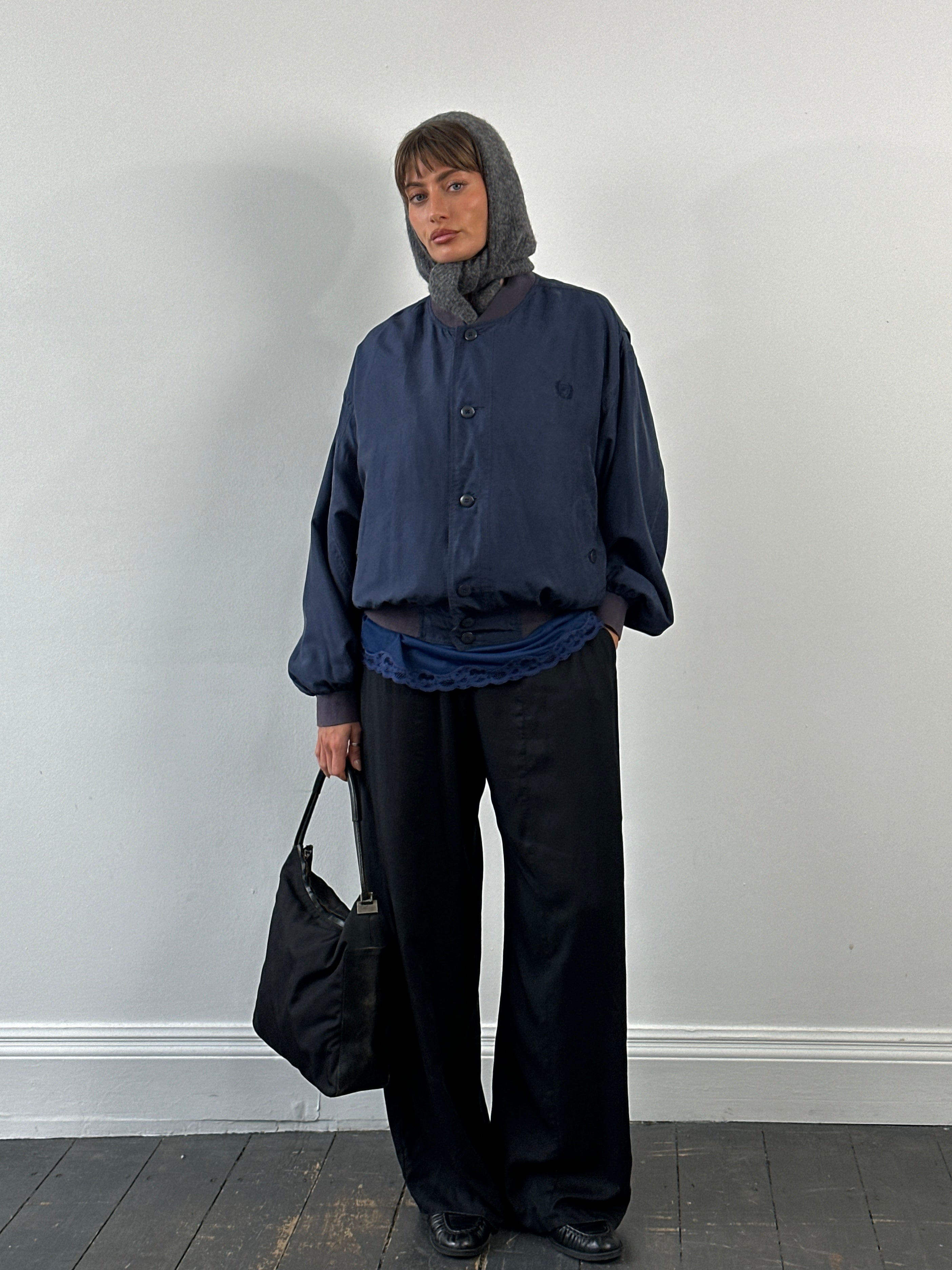 Vintage 1990s pure silk bomber jacket in size L, featuring a shiny finish and classic athletic style.