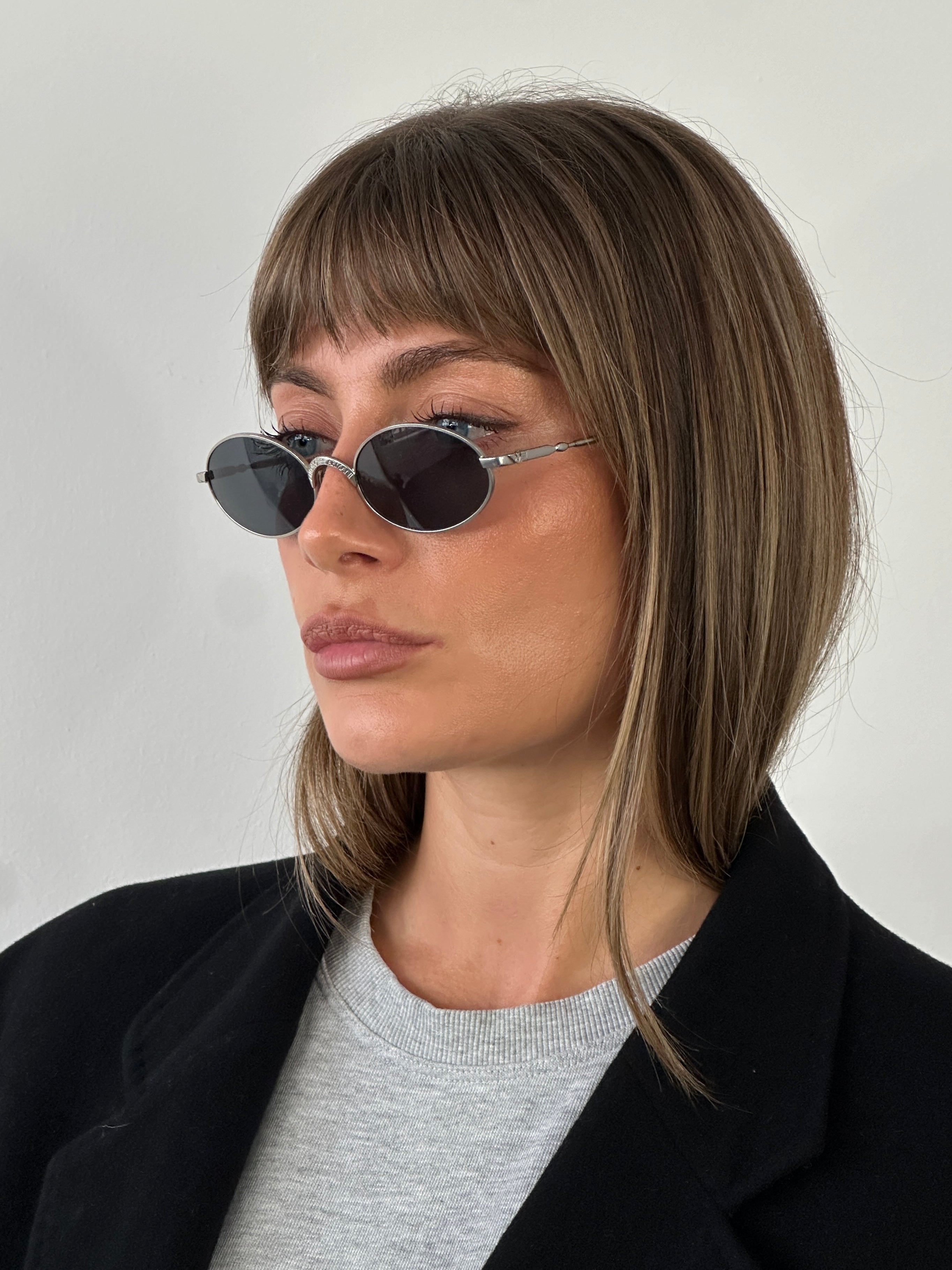 Emporio Armani metal oval sunglasses with sleek frames and dark lenses, stylish eyewear for a modern look.
