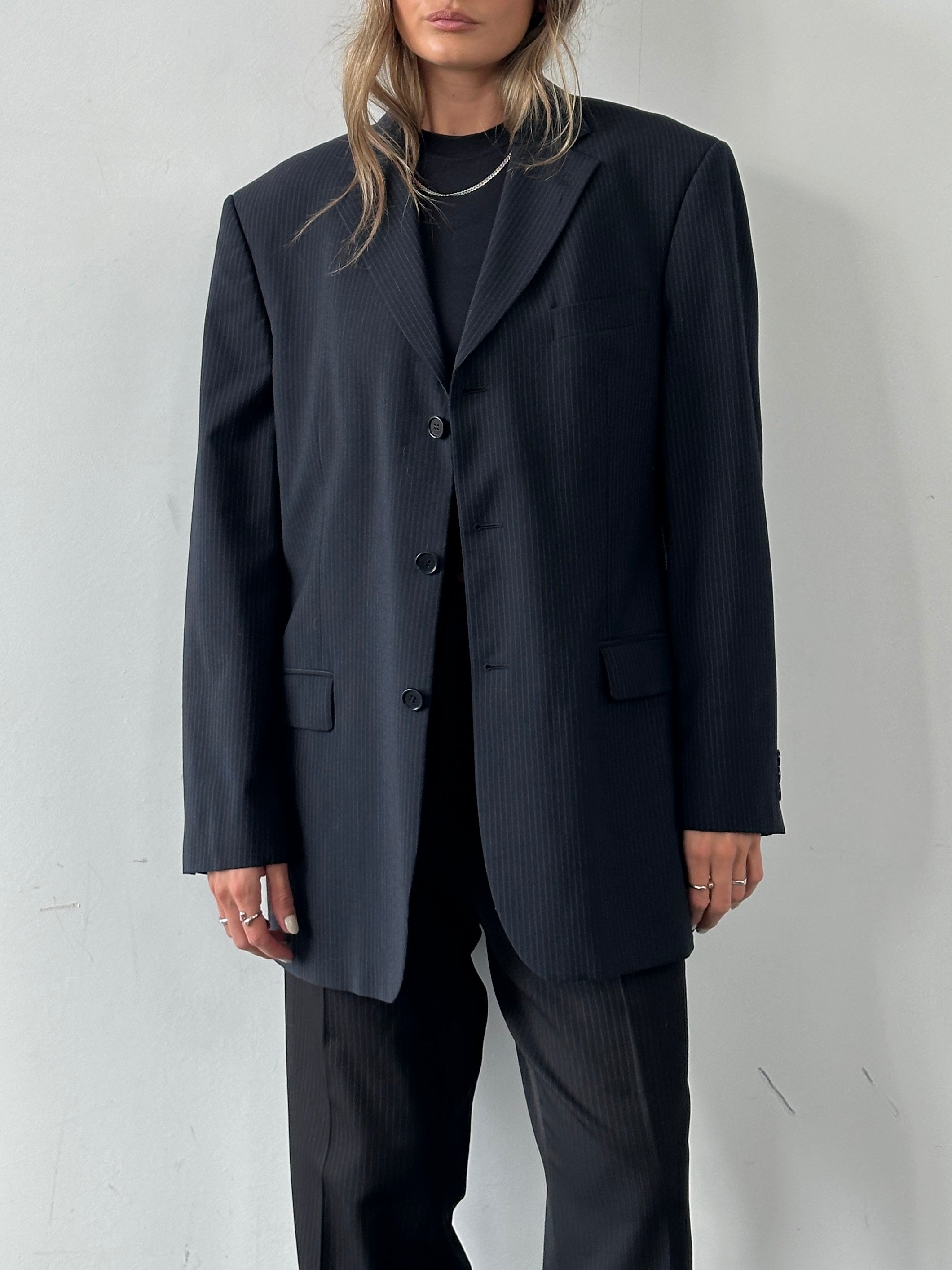 Balmain pinstripe wool blazer, single-breasted with notch lapels and structured fit, size 42R/XL, on a hanger.
