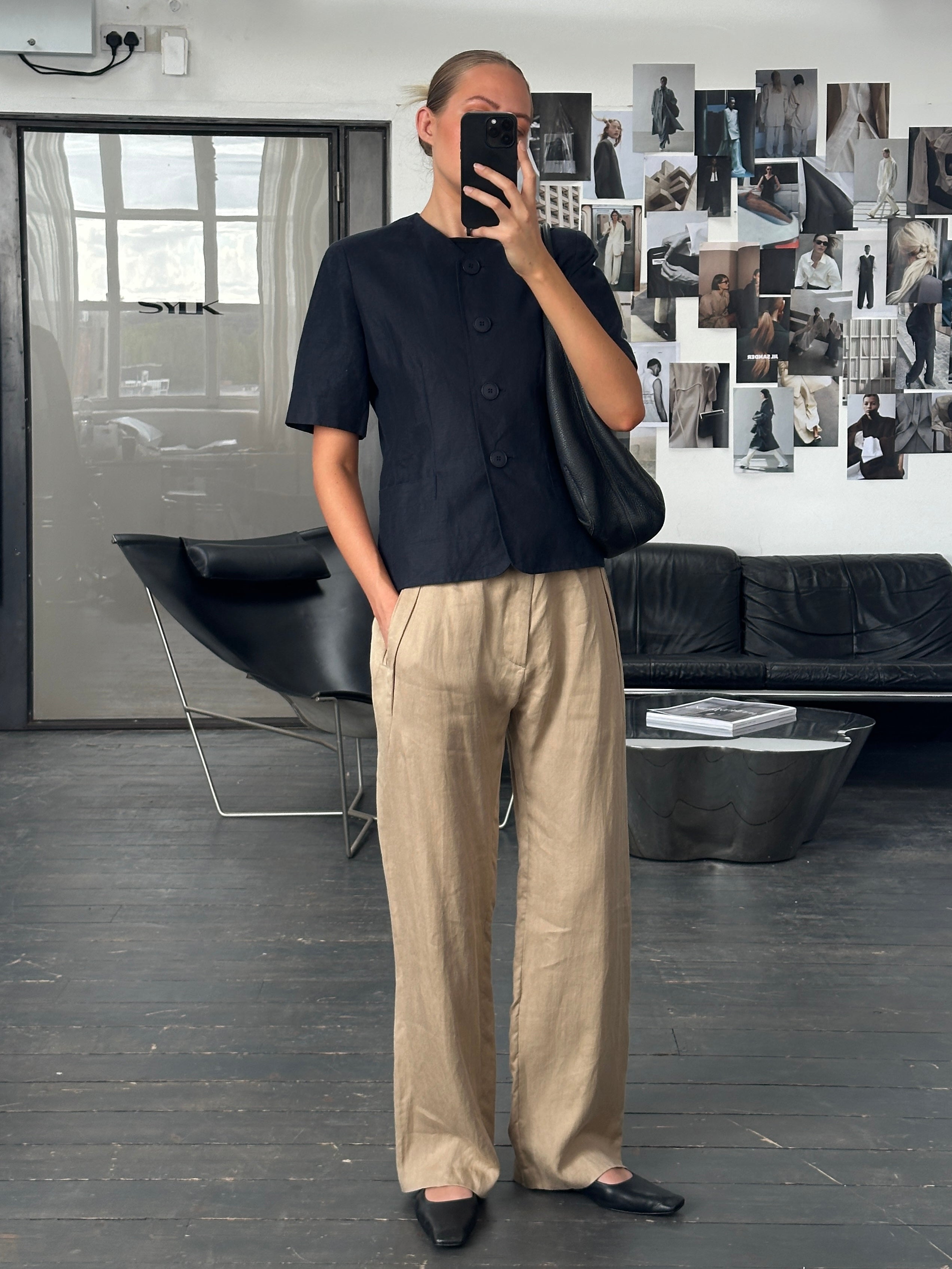 Luisa Spagnoli 1990s pure linen short sleeve tailored blazer in beige, displayed on a hanger with a classic fit and clean lines.