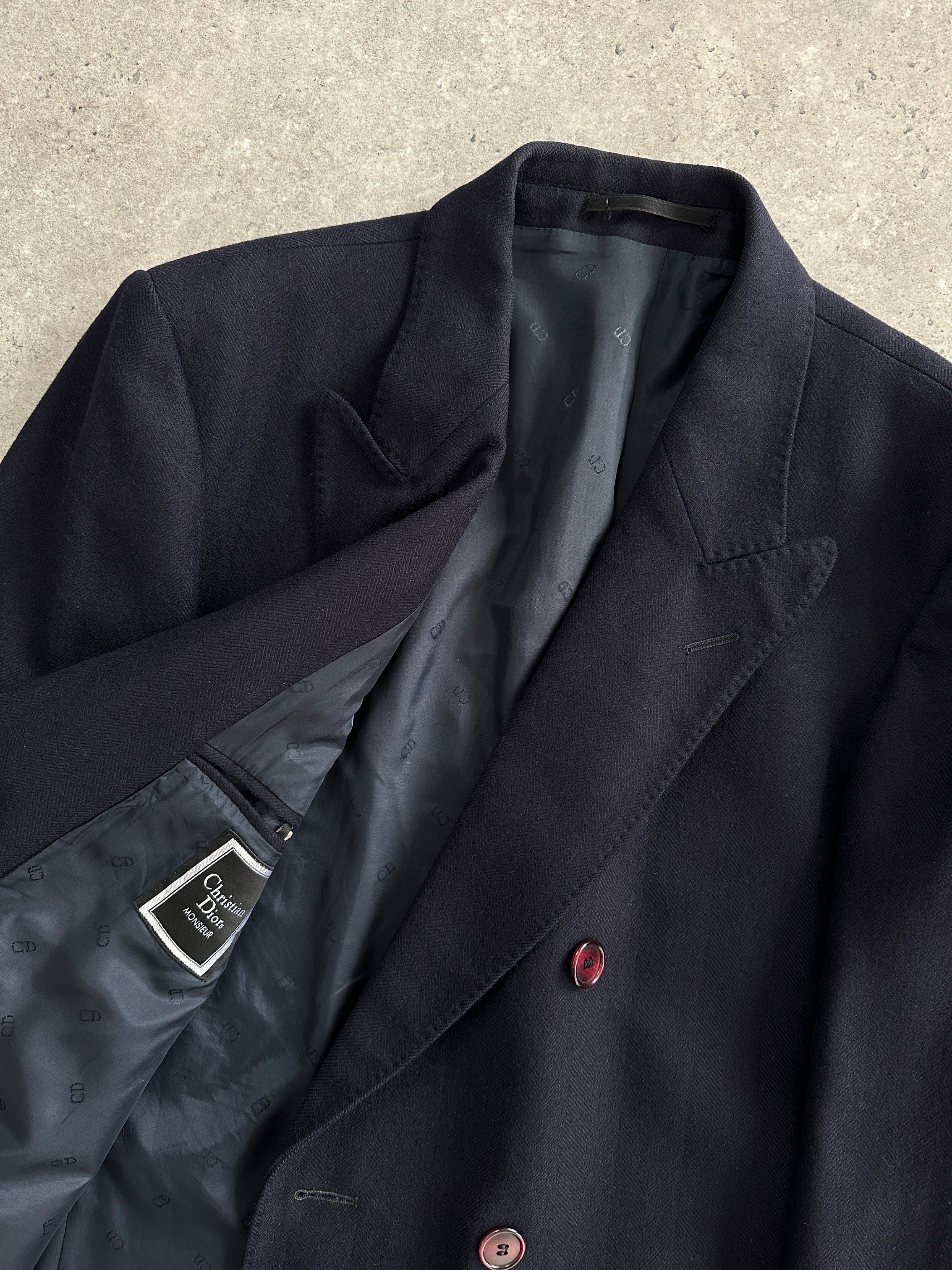 Christian Dior pure wool double-breasted coat in XL/XXL, featuring classic design and tailored fit, displayed on a hanger.