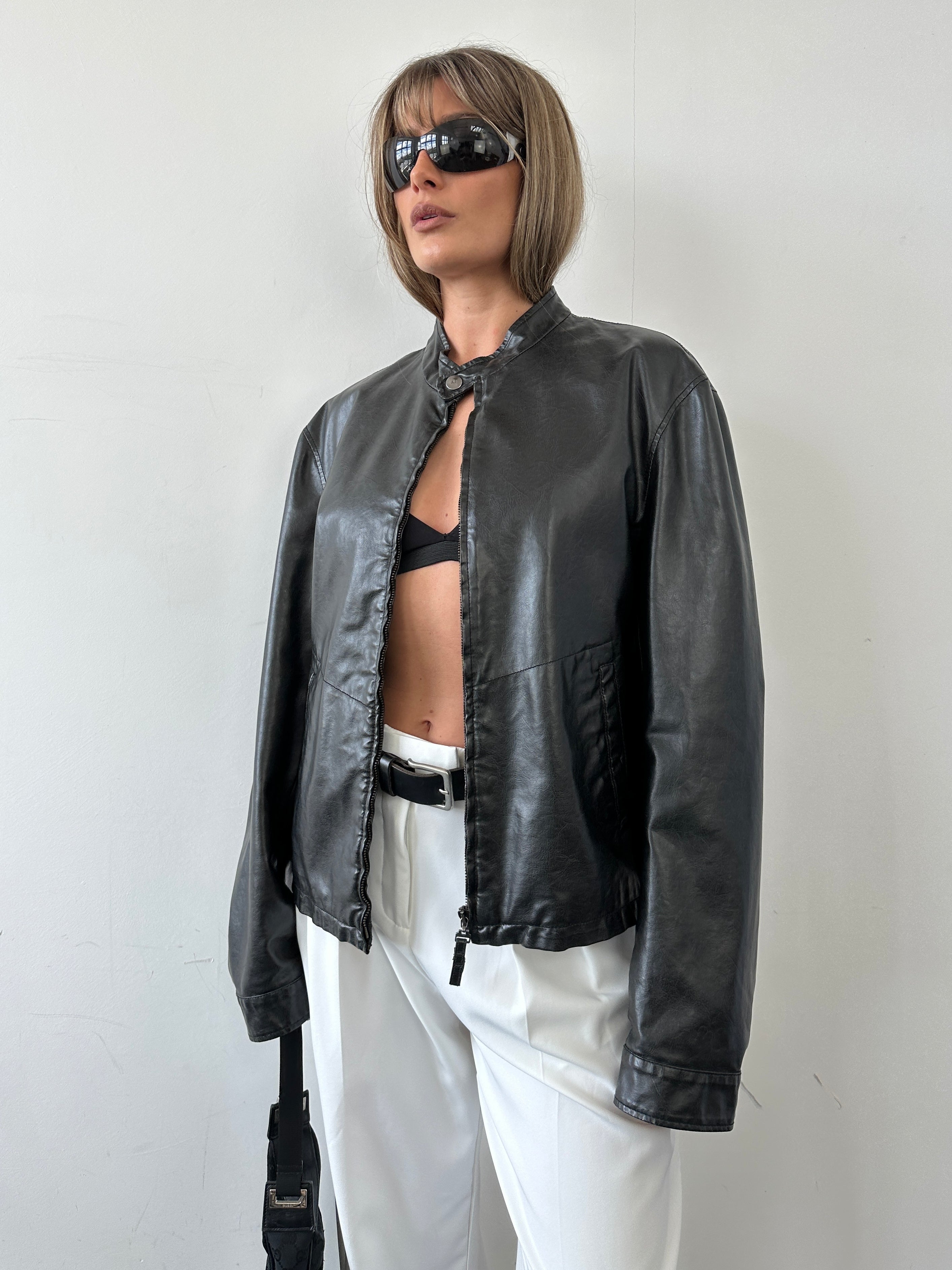 Armani Jeans faux leather biker jacket in size M, featuring a classic design with zippered details and a sleek black finish.