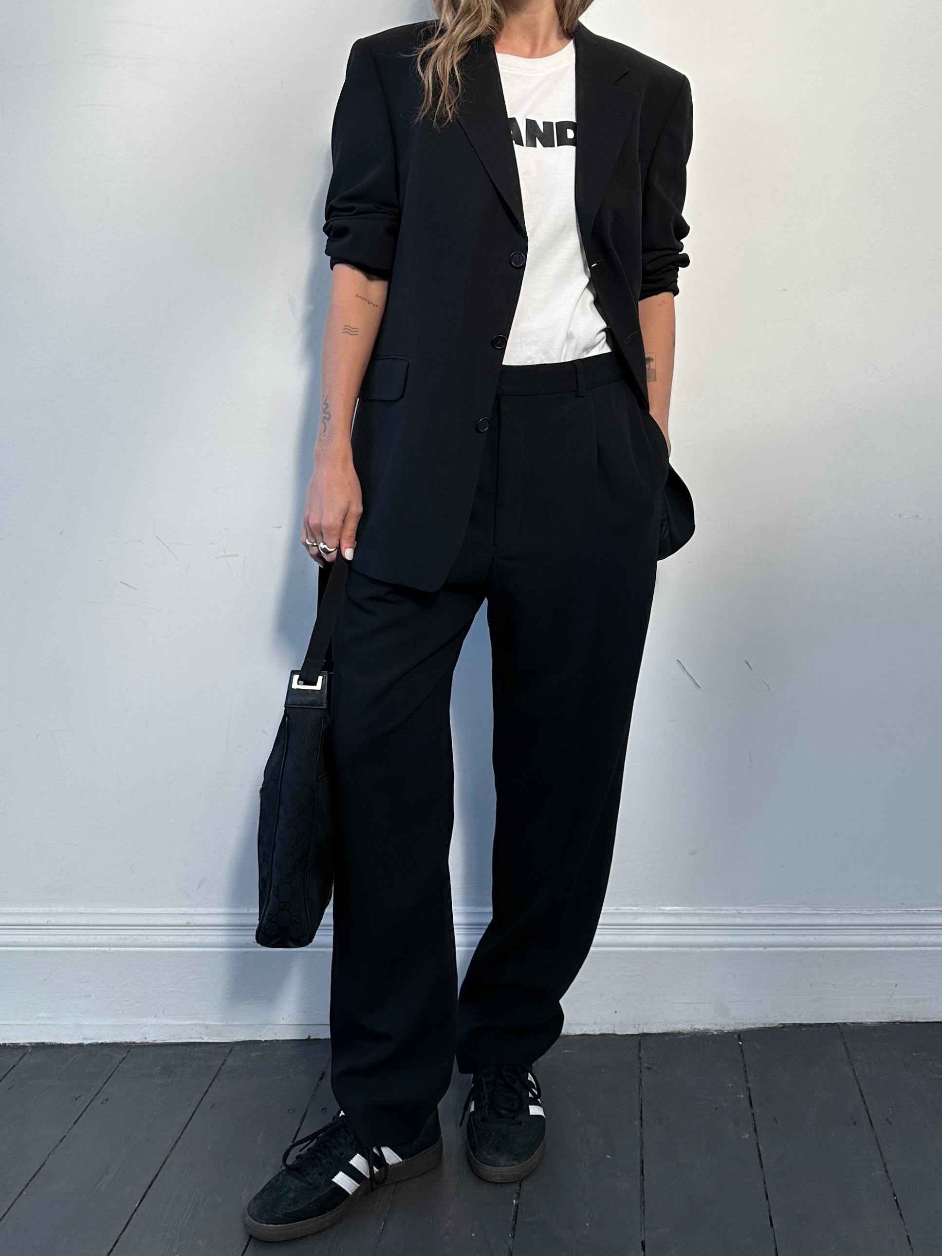 Yves Saint Laurent pure wool jumpsuit in size 42R/W32, tailored fit with classic design, shown on a neutral background.