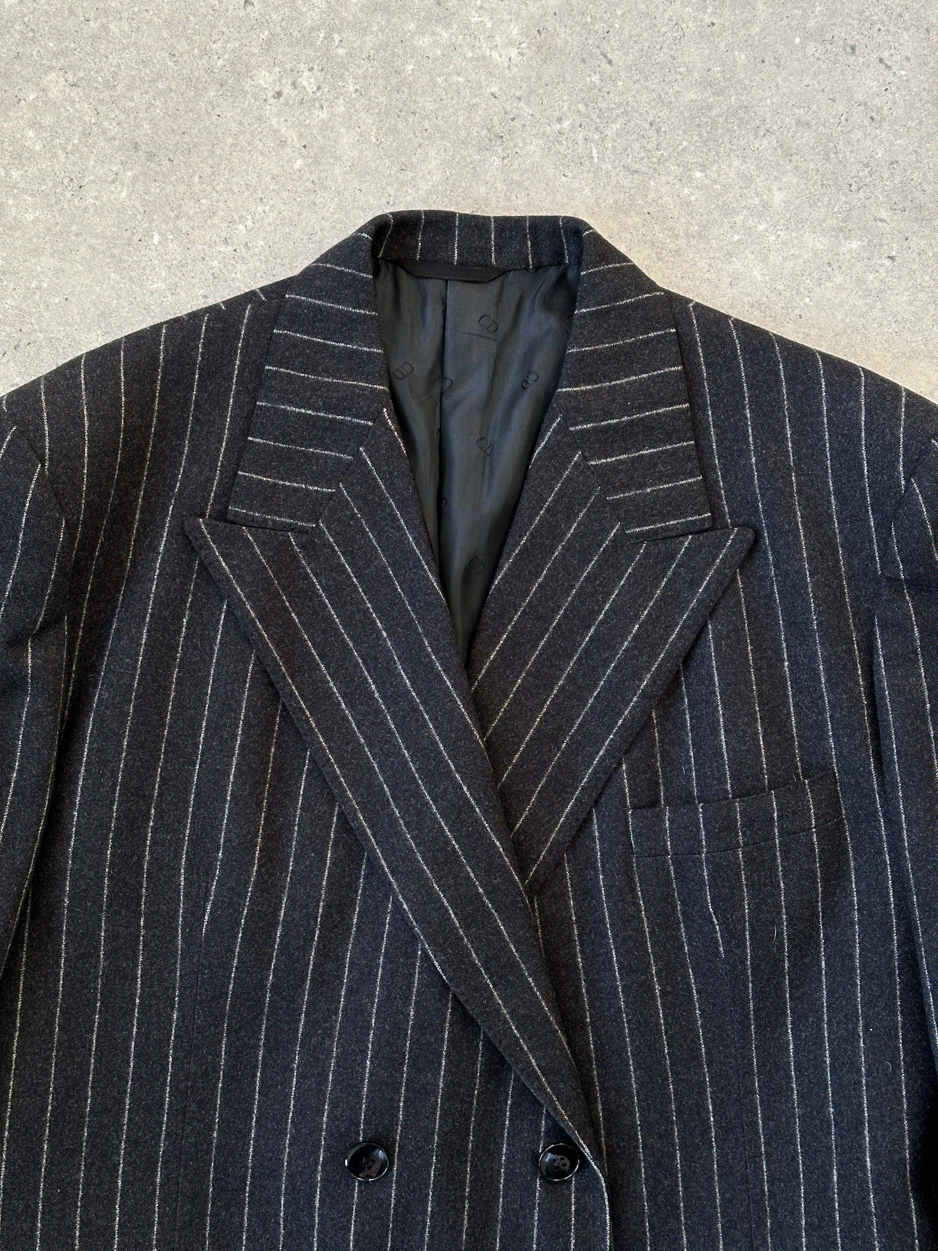 Christian Dior pure wool double-breasted pinstripe jumpsuit in size 45L/W32, featuring tailored lapels and a fitted silhouette.