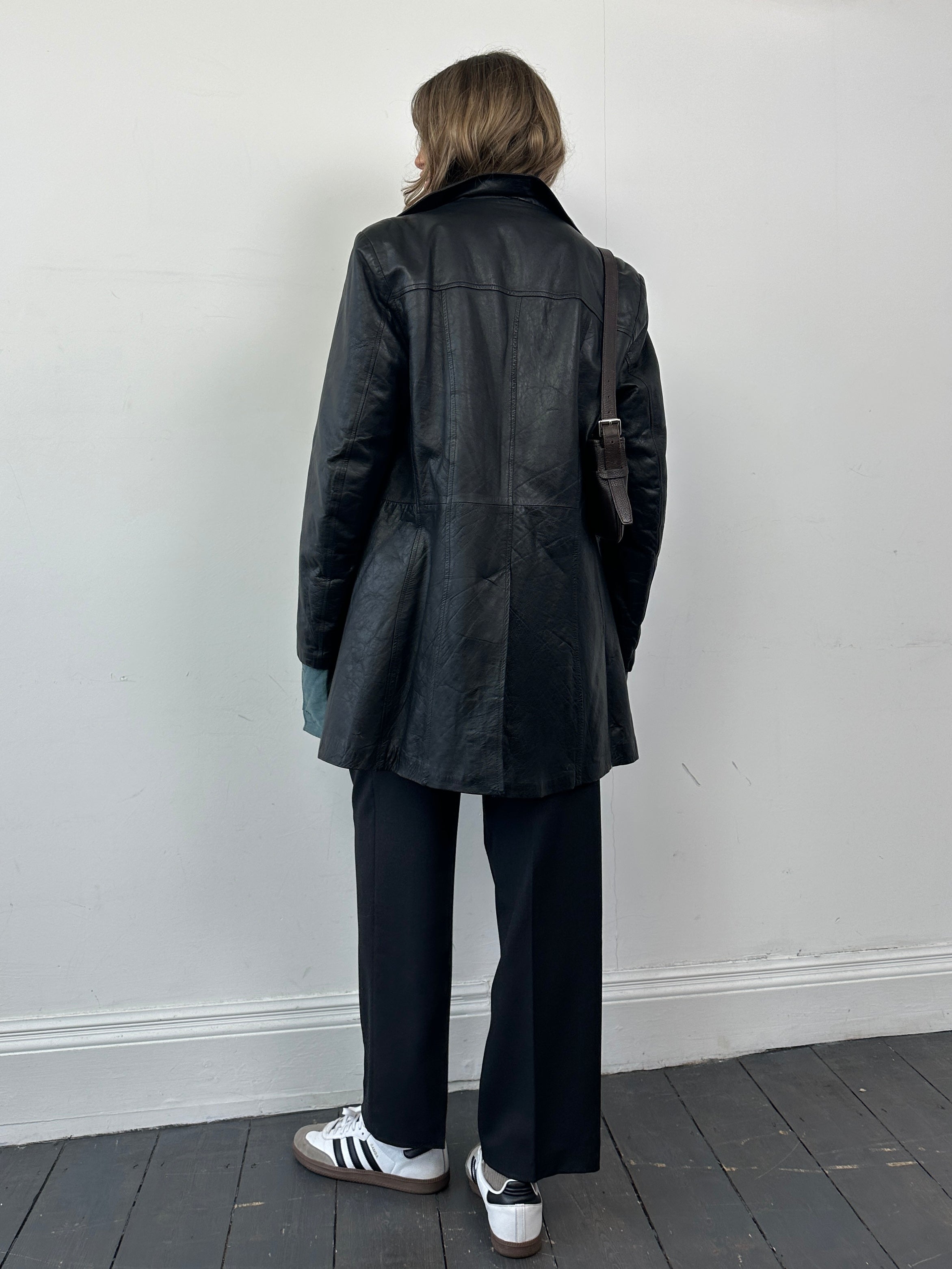 Vintage Italian double-breasted leather jacket in mid-length style, featuring classic design and tailored fit for S/M size.