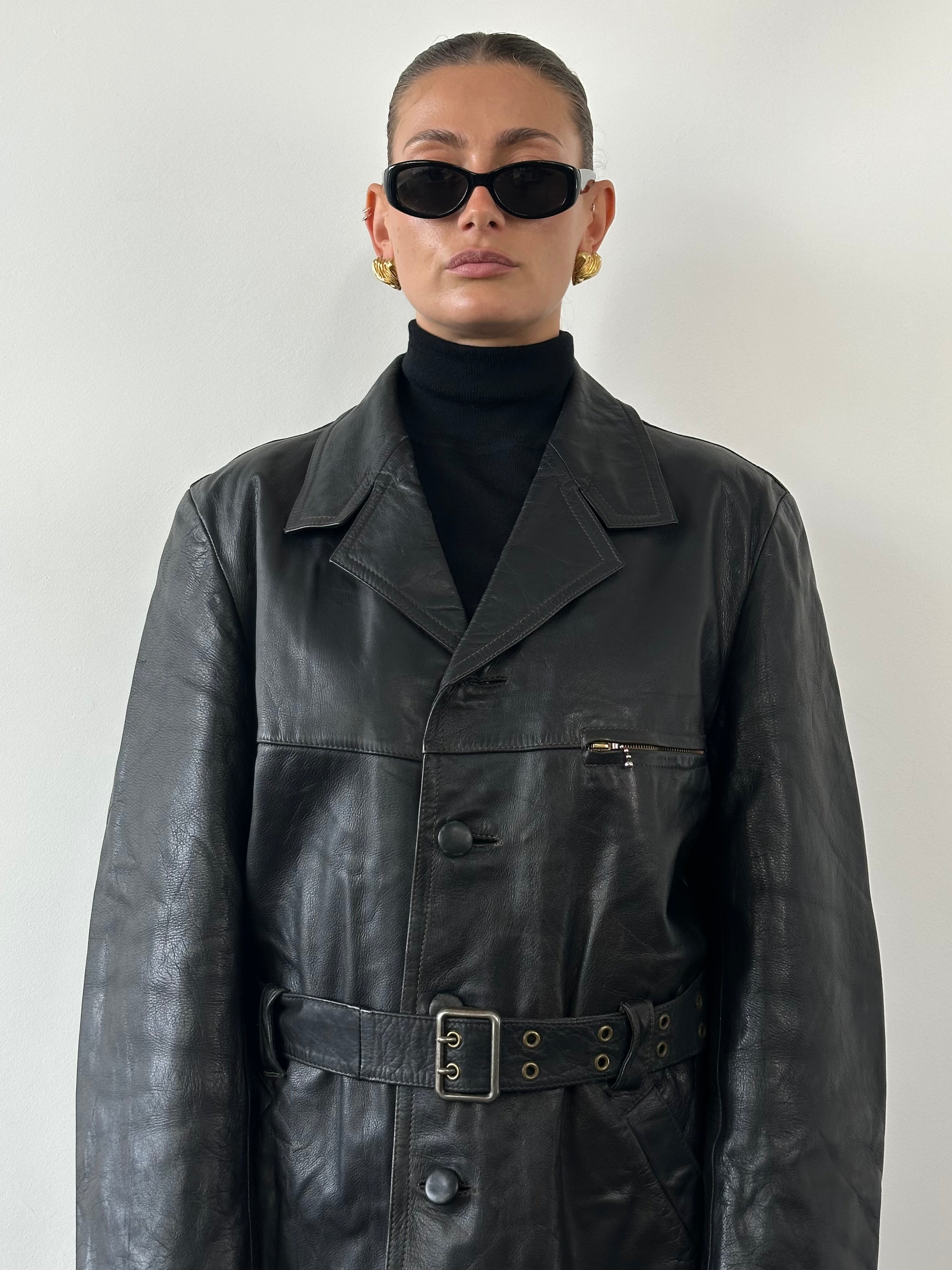 Vintage belted leather jacket in XL size, featuring classic design and durable leather material, displayed on a hanger.