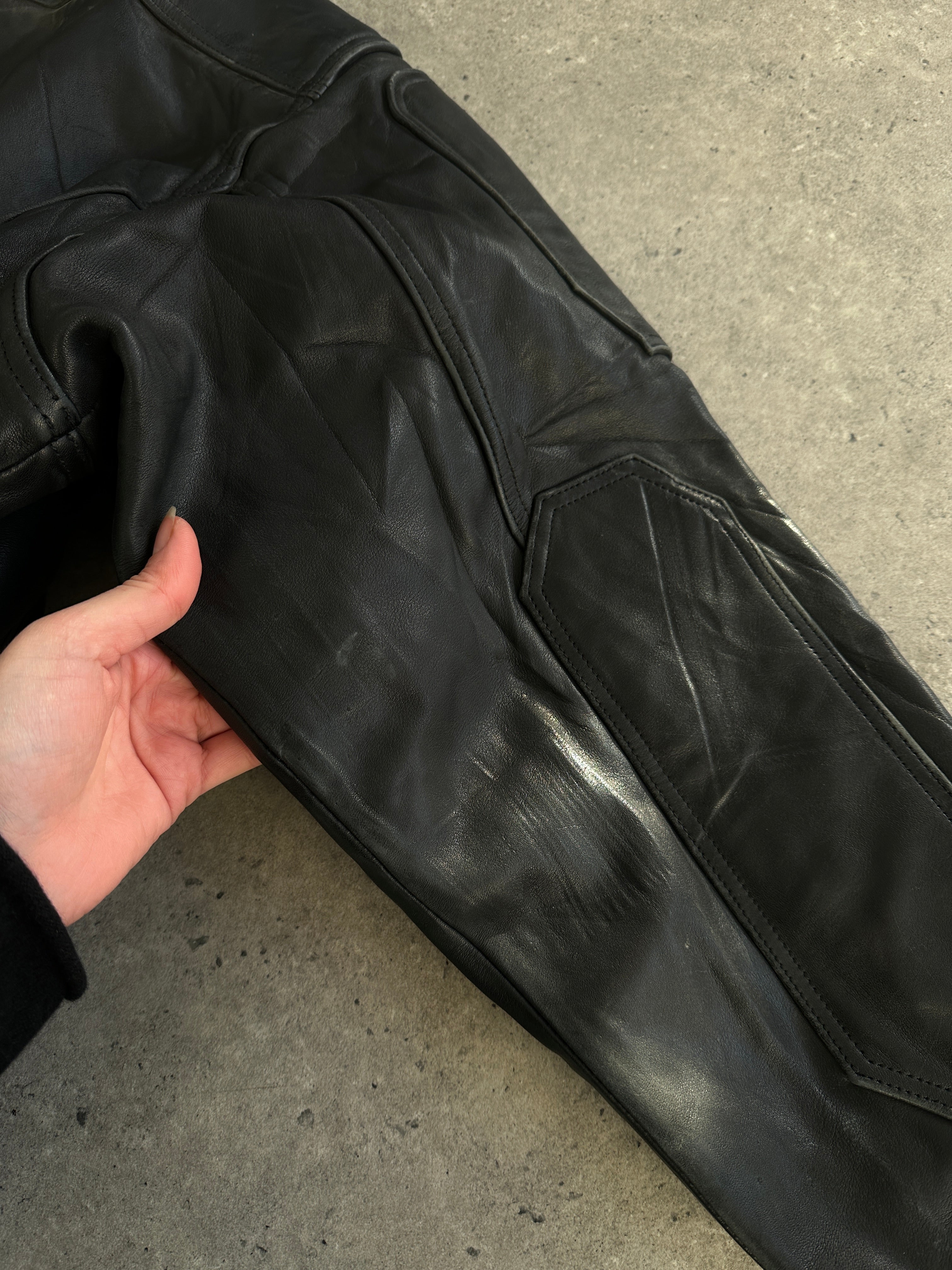 Vintage leather jacket in size XL, featuring classic design and durable leather material, displayed on a hanger.